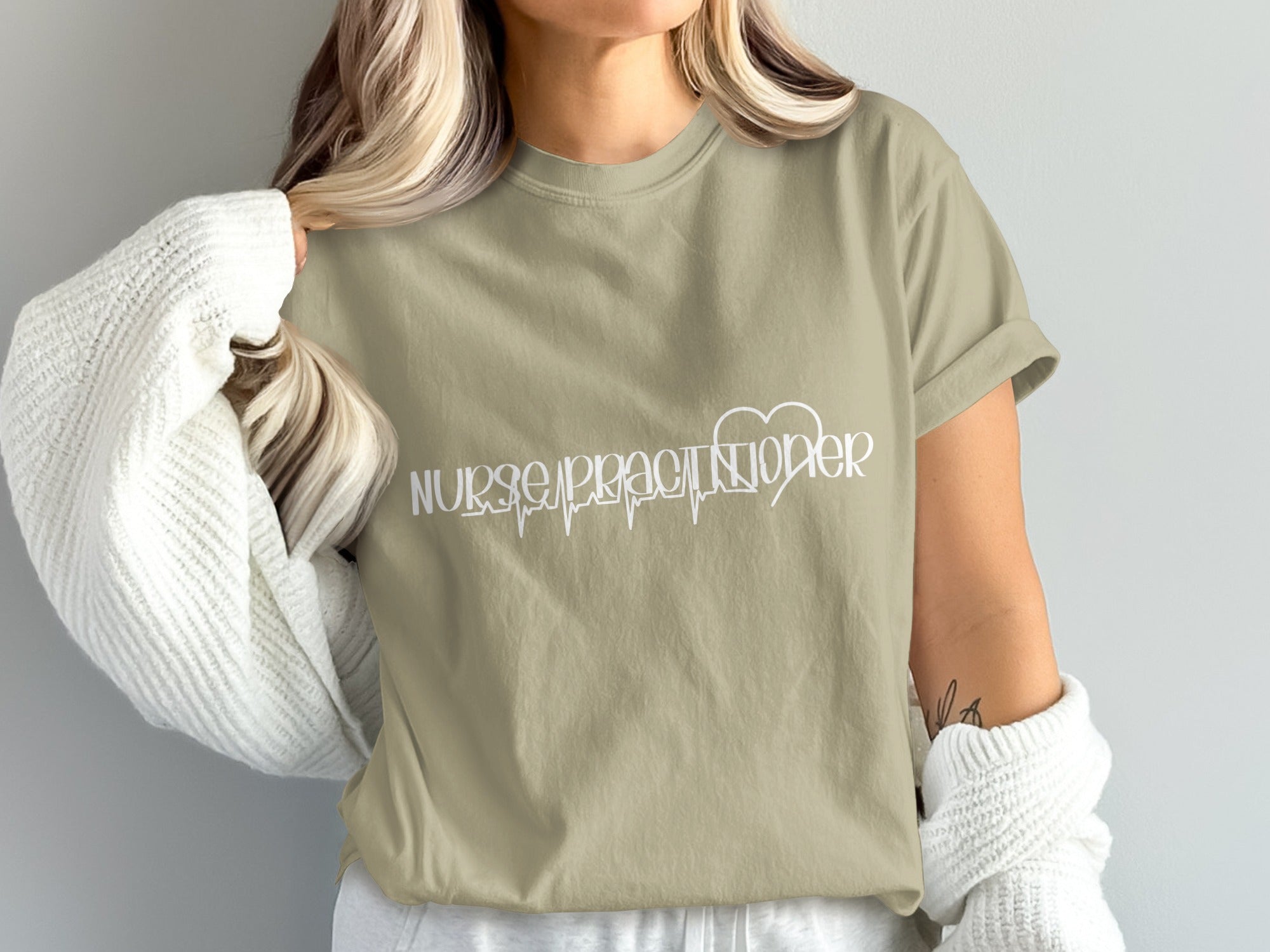 Tan t-shirt with "Nurse Practitioner" text and a heartbeat line.