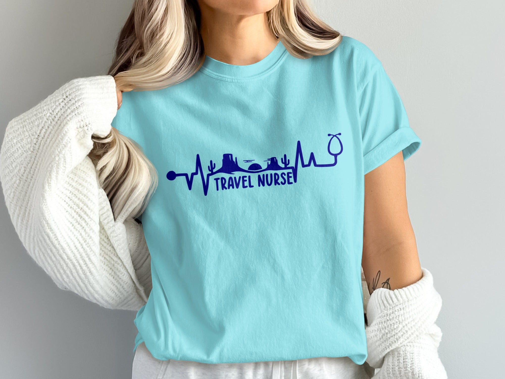 Teal t-shirt with "Travel Nurse" text and stethoscope heartbeat design.