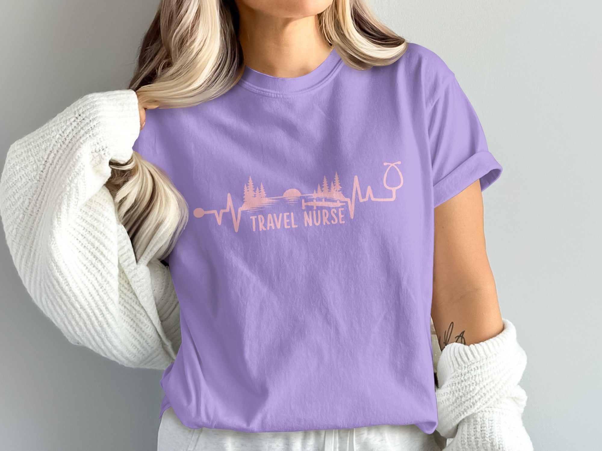 Purple t-shirt with "Travel Nurse" text and landscape within a heartbeat graphic.