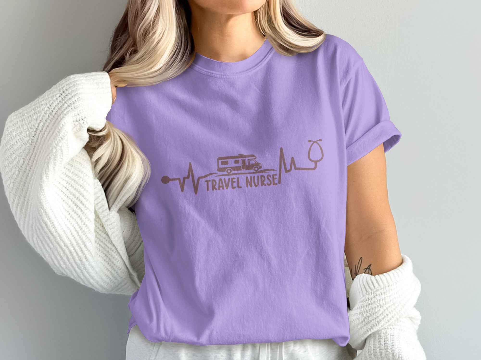 Purple t-shirt with a heartbeat line, RV, and stethoscope forming "Travel Nurse".