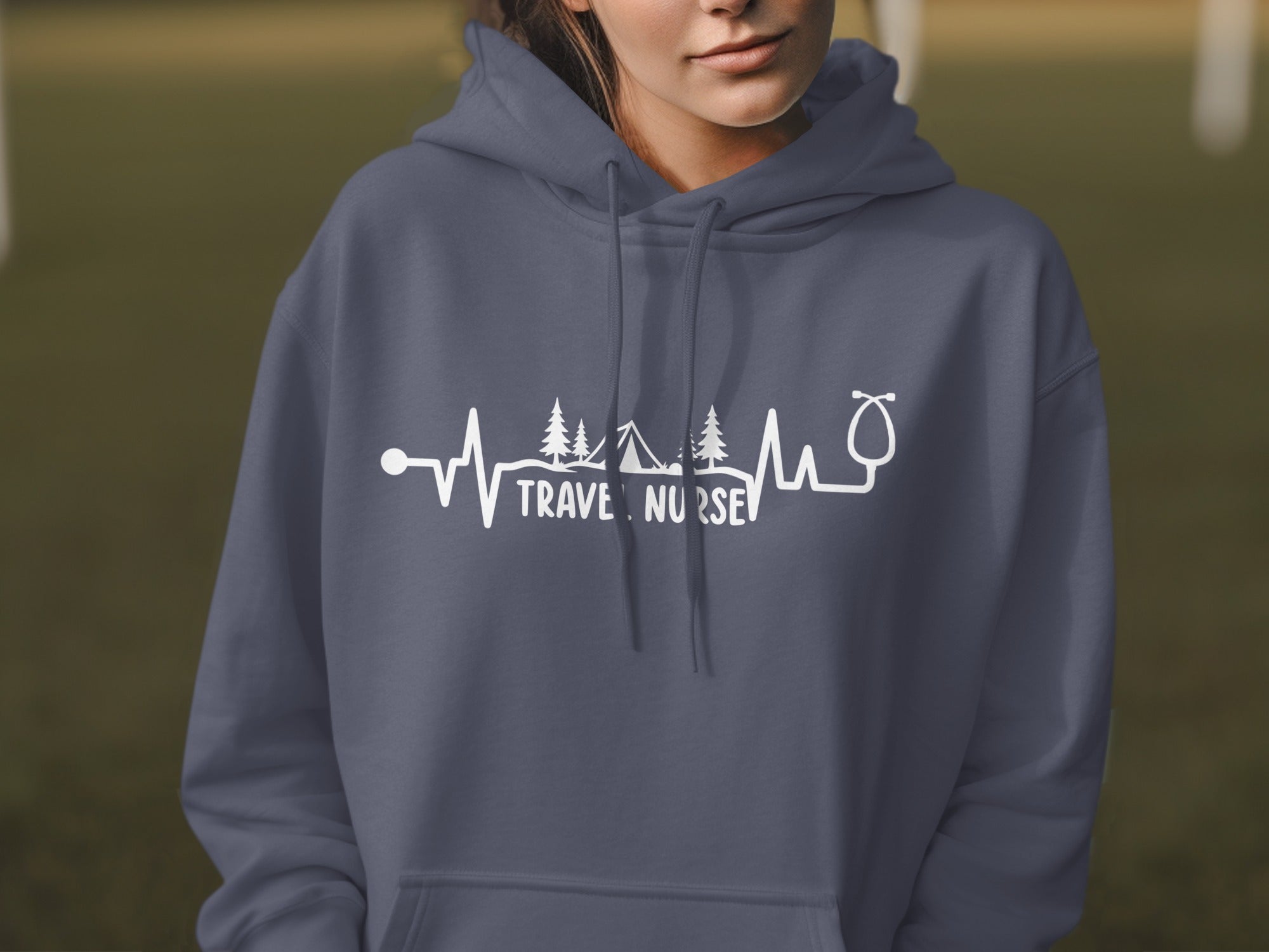 Dark grey hoodie with "Travel Nurse" text and medical/outdoor graphic.