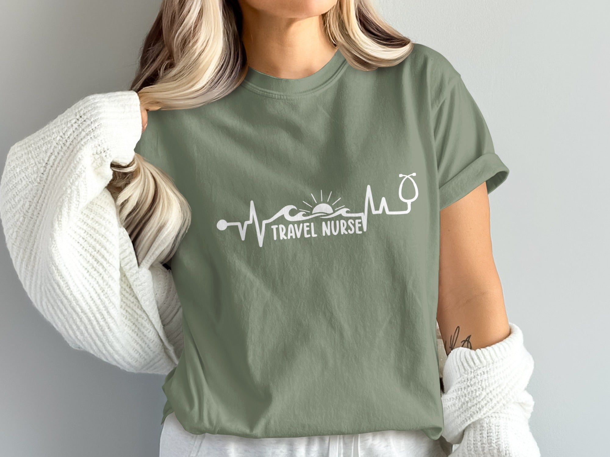Olive green t-shirt with "TRAVEL NURSE" text and stethoscope heartbeat graphic.