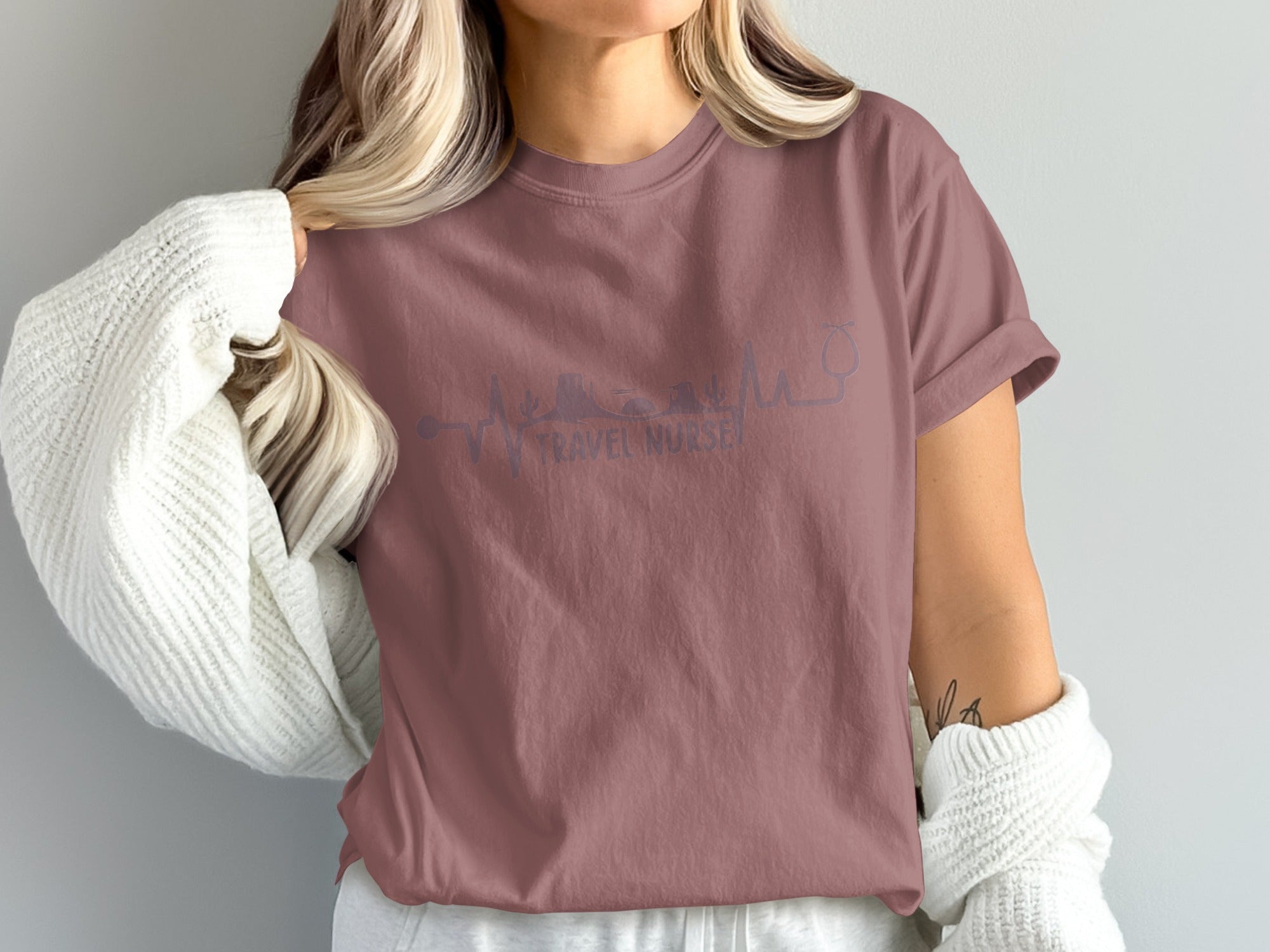 Mauve t-shirt with stethoscope and "TRAVEL NURSE" text.