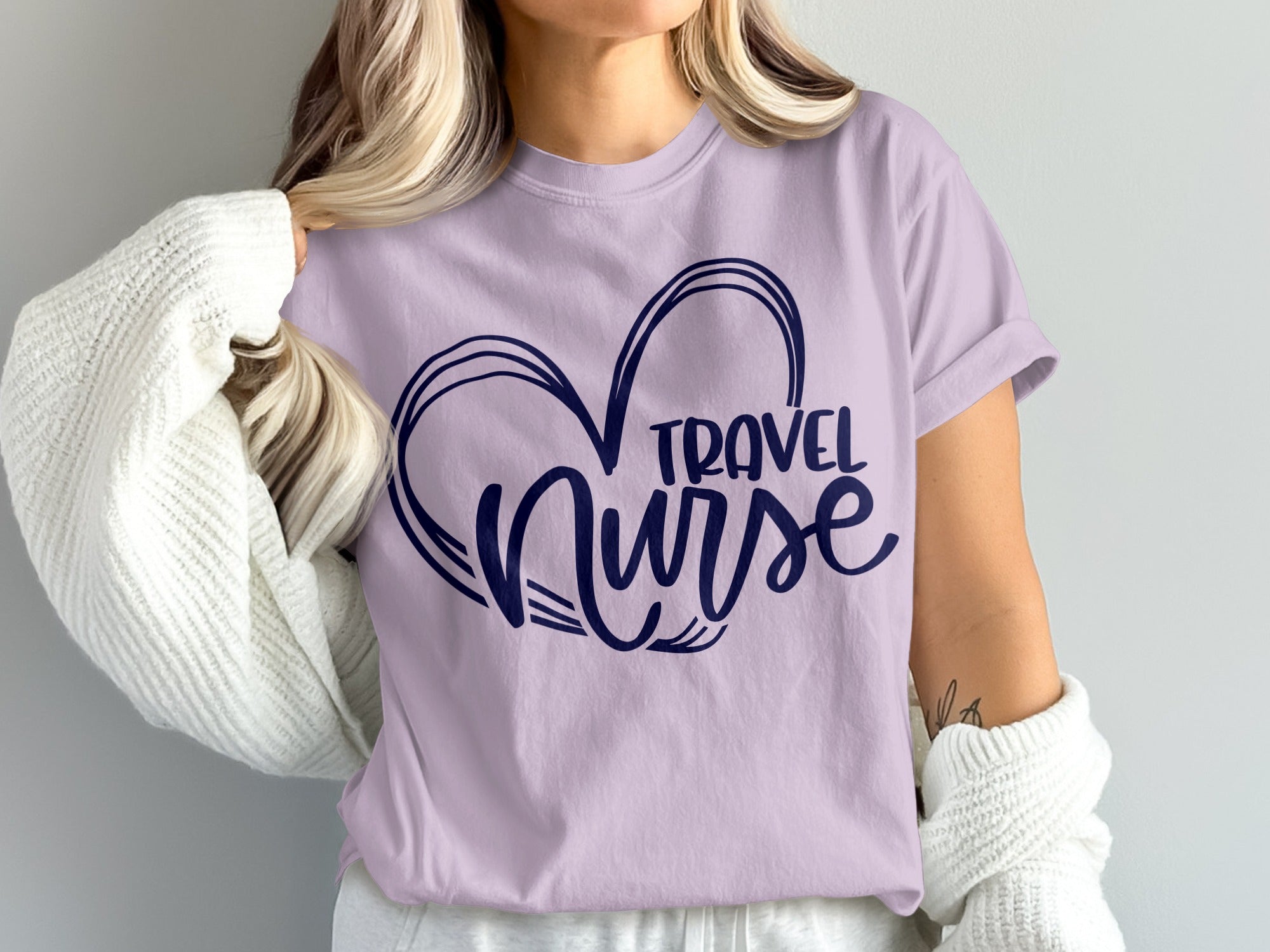 Lavender t-shirt with navy blue "Travel Nurse" text inside a heart design.