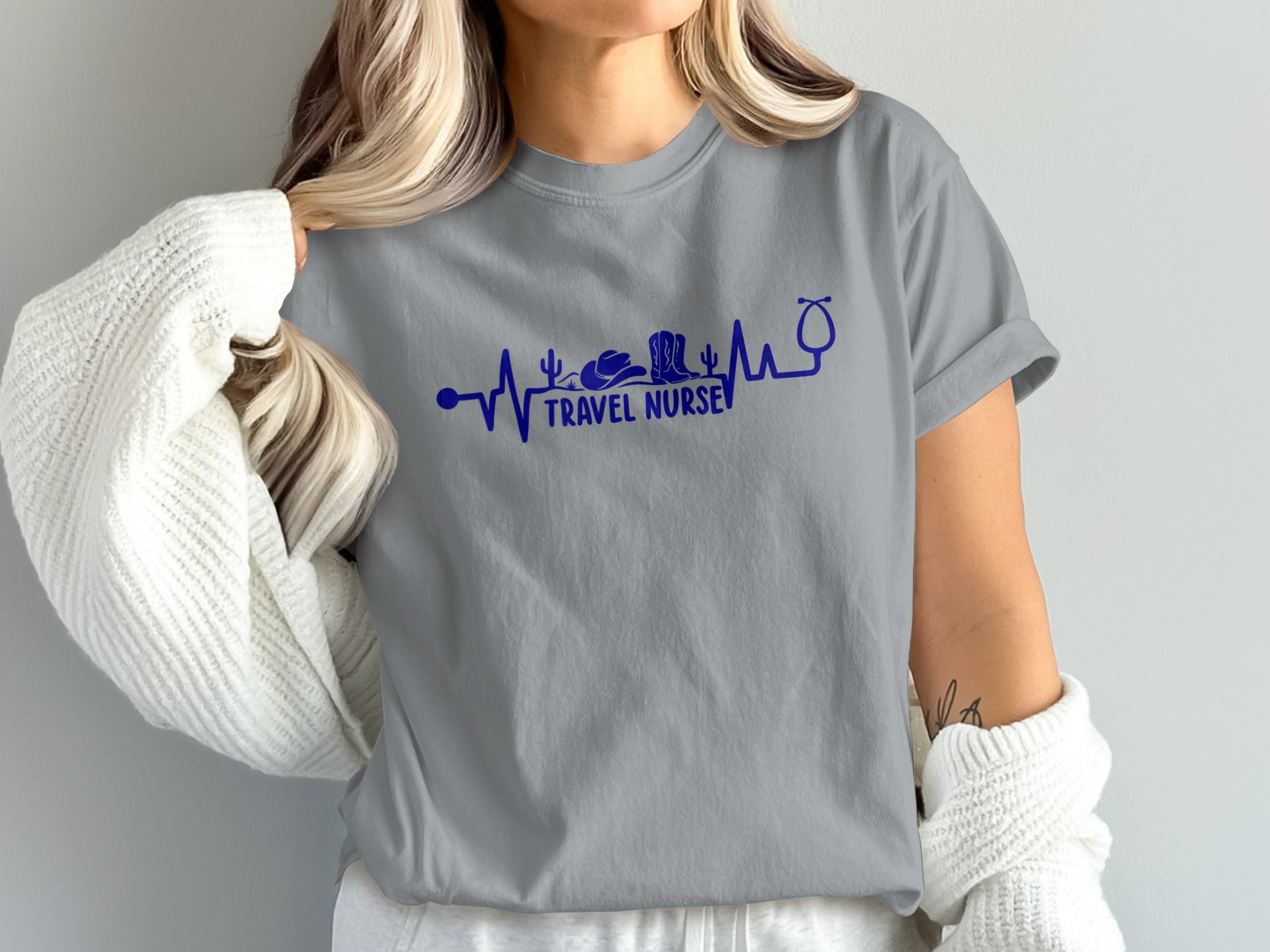Gray t-shirt with a blue stethoscope heartbeat graphic and "TRAVEL NURSE" text.