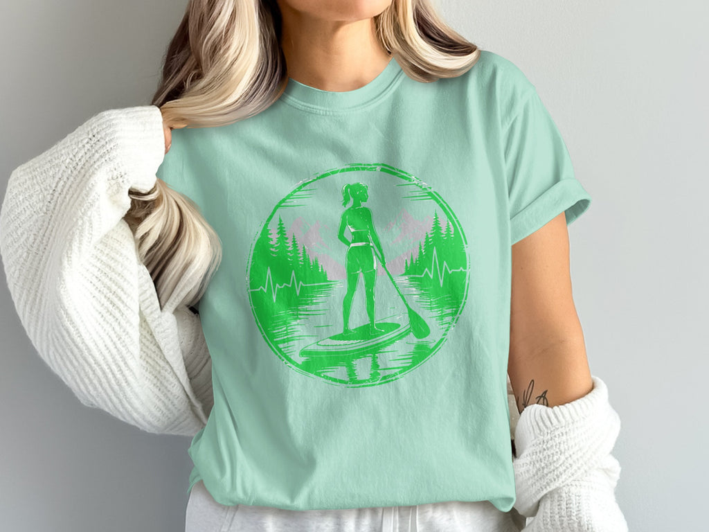 Green graphic of woman paddleboarding on water with heartbeat line and trees.