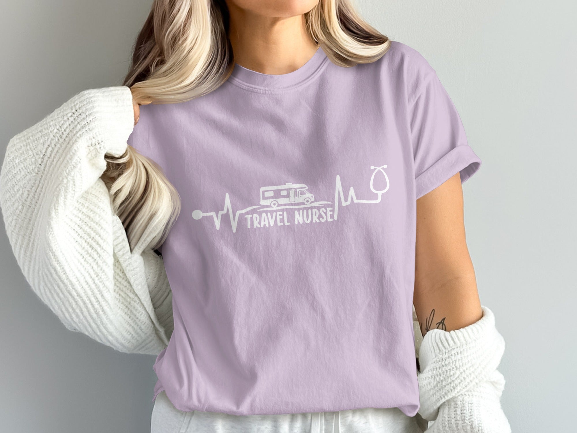 Purple t-shirt with "TRAVEL NURSE" text and RV and stethoscope graphic.