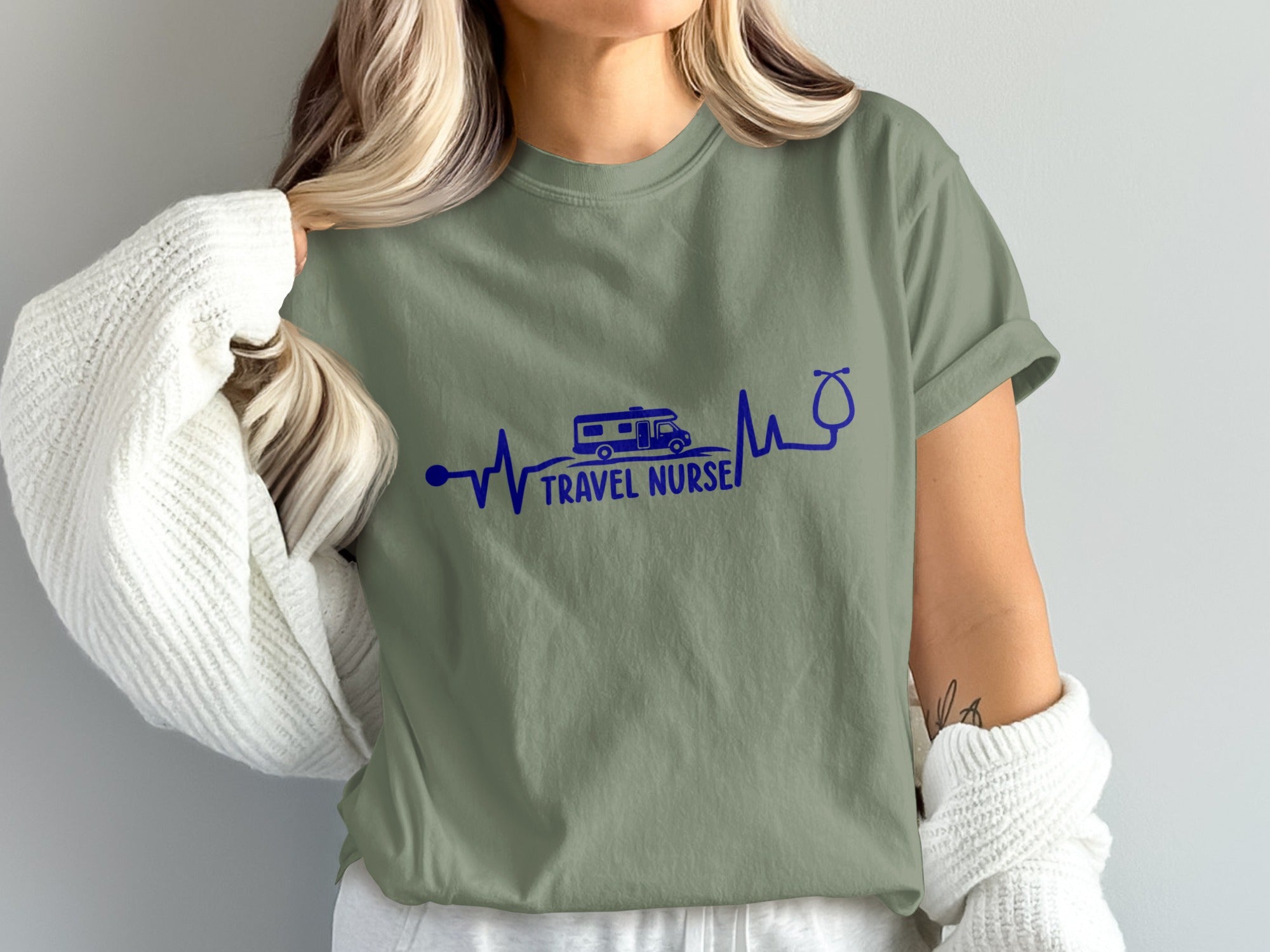 Olive green t-shirt with "TRAVEL NURSE" text and RV and stethoscope graphic.
