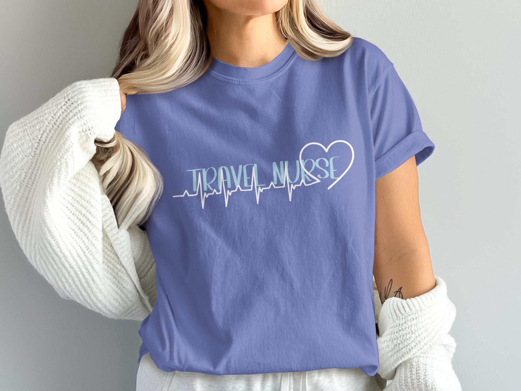 Purple t-shirt with "Travel Nurse" and a heartbeat line with a heart.