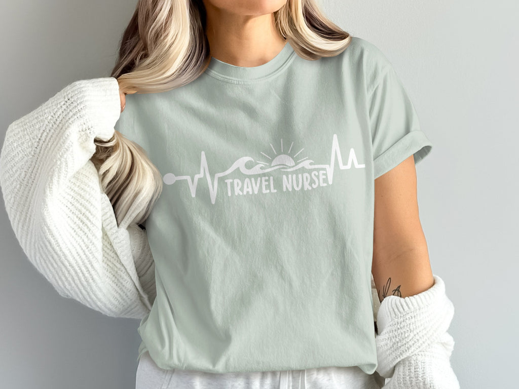 Light green t-shirt with white "Travel Nurse" text and heartbeat wave graphic.