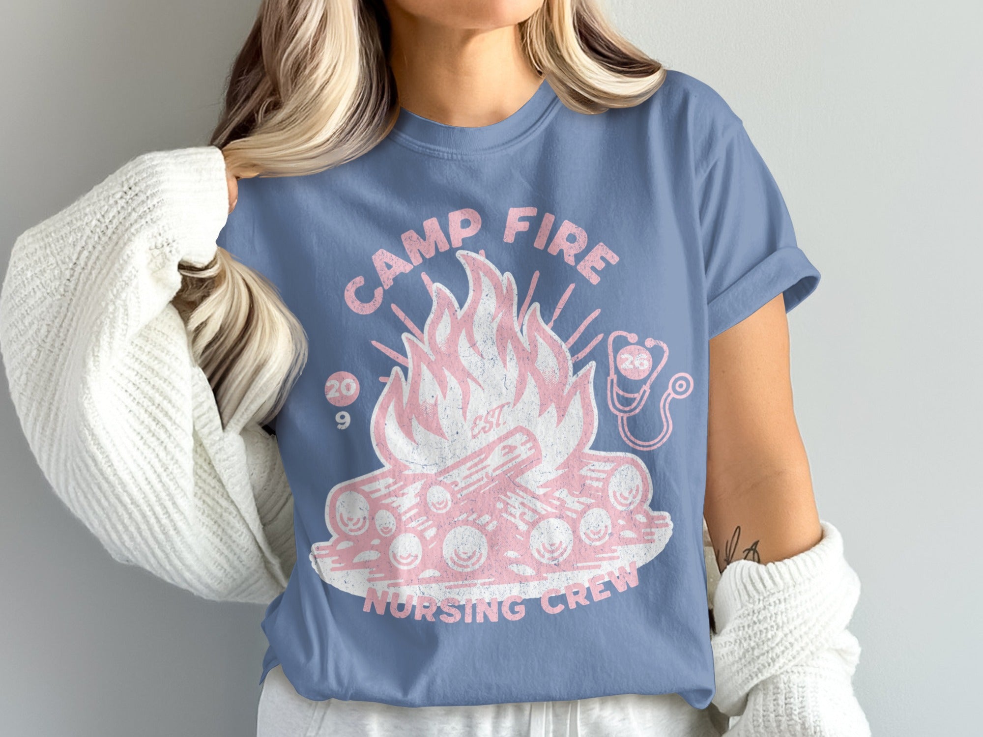 Camp Fire Nursing Crew t-shirt with pink flames, logs, and stethoscope.
