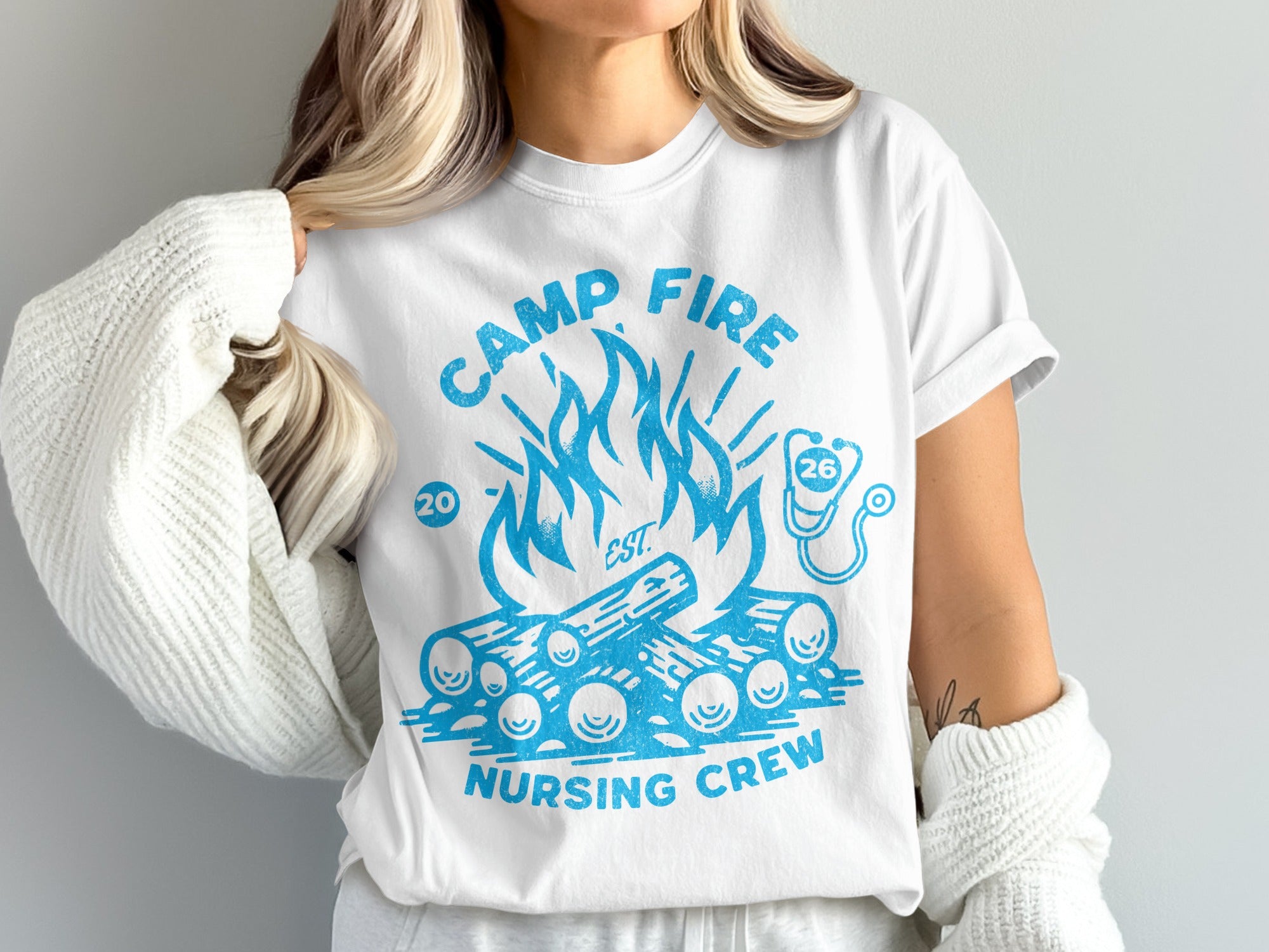 White t-shirt with "Camp Fire Nursing Crew" and campfire graphic.
