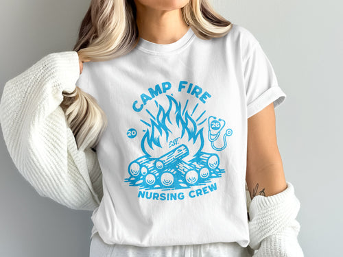 White t-shirt with blue "Camp Fire Nursing Crew" graphic featuring campfire and stethoscope.