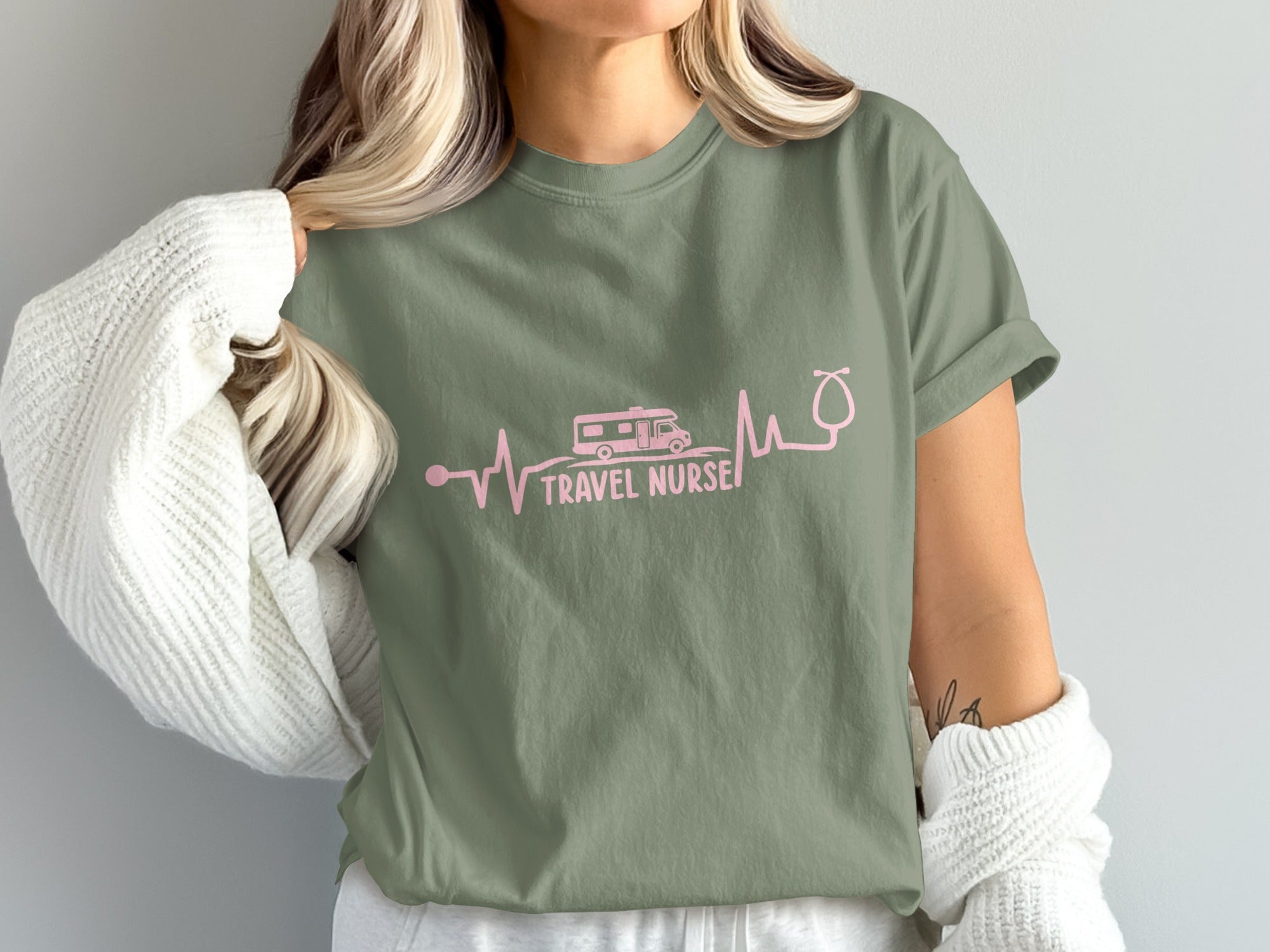 Green t-shirt with pink heartbeat graphic, RV, and "TRAVEL NURSE" text.