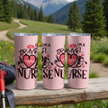 Three pink travel mugs with "I'm a Travel Nurse" text and medical symbols.