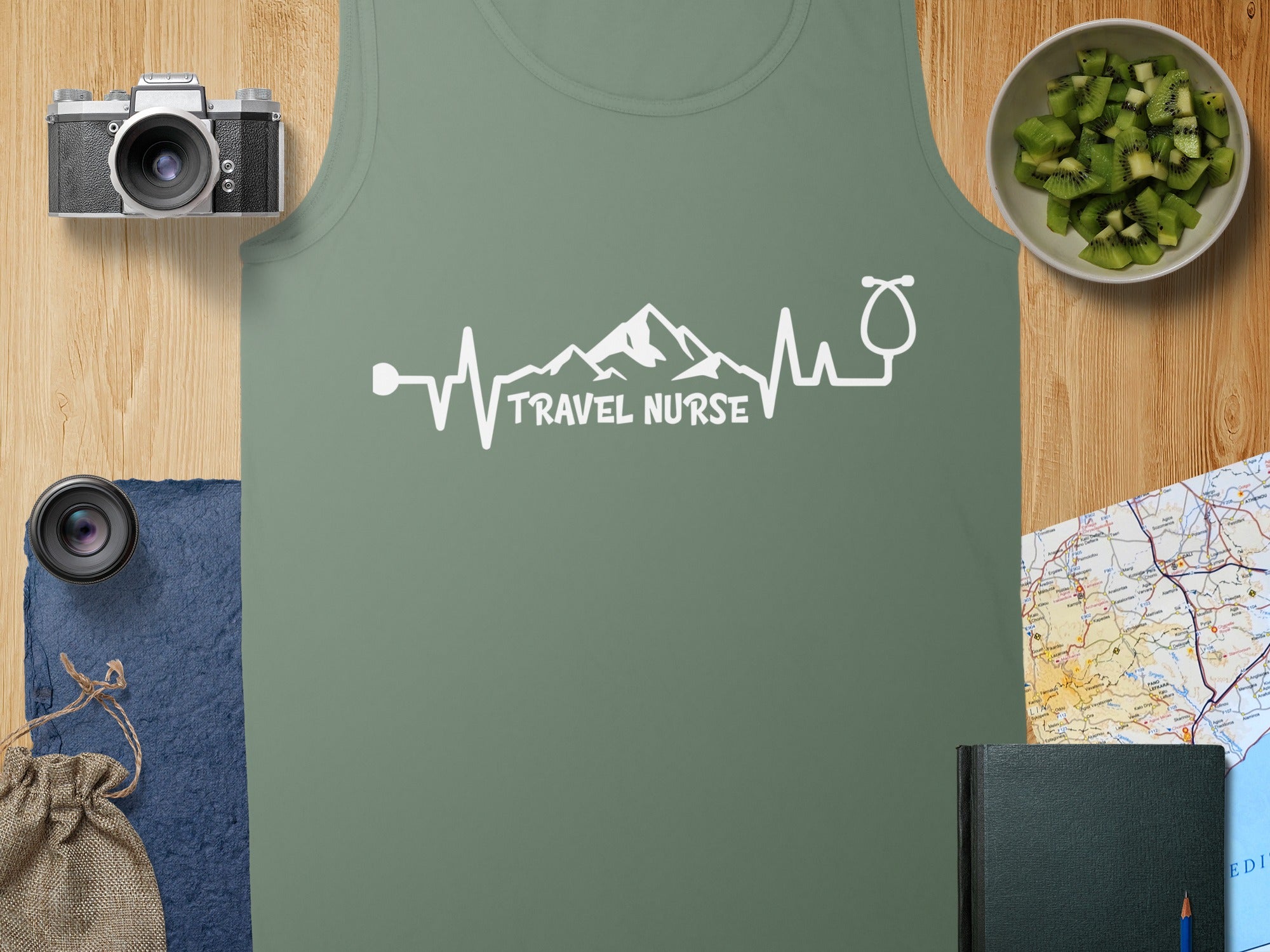 Green tank top with "TRAVEL NURSE" in a heartbeat and stethoscope design.