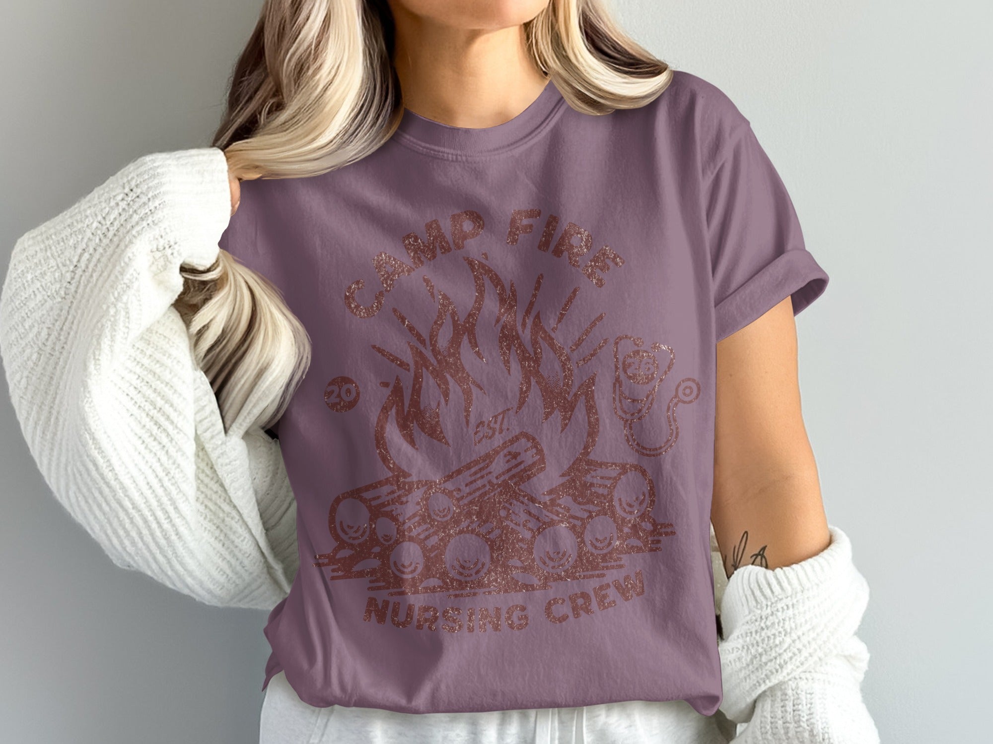 Rose-colored t-shirt with "CAMP FIRE NURSING CREW" and a campfire graphic.