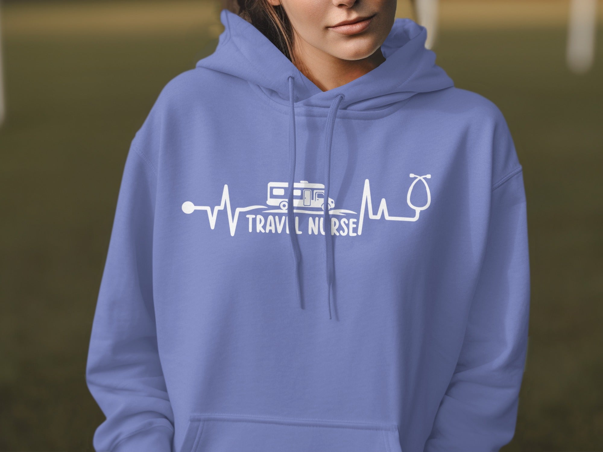 Purple hoodie with "TRAVEL NURSE" text and heartbeat graphic with camper and stethoscope.
