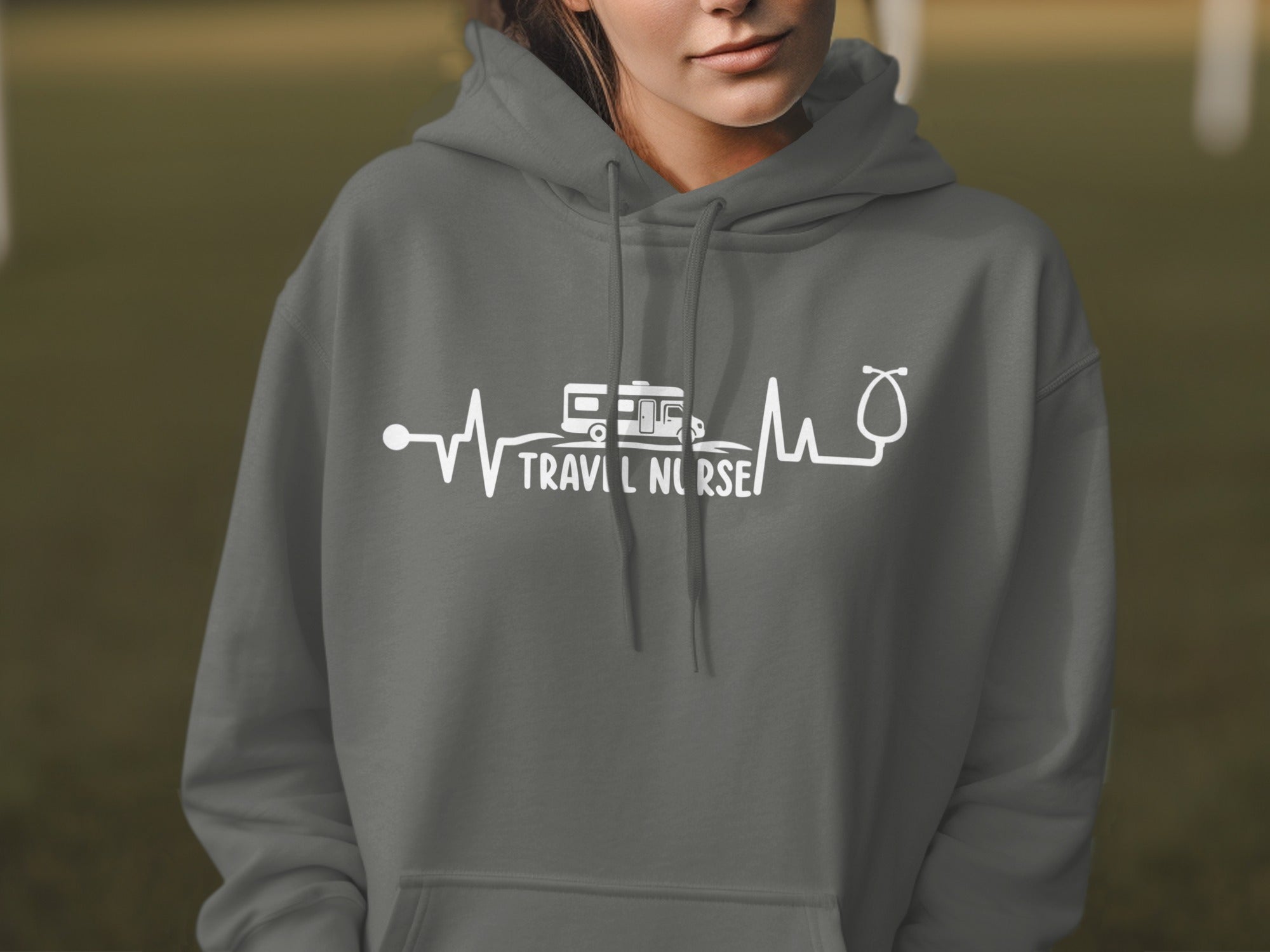 Gray hoodie with white graphic of heartbeat, RV, and stethoscope for "Travel Nurse".