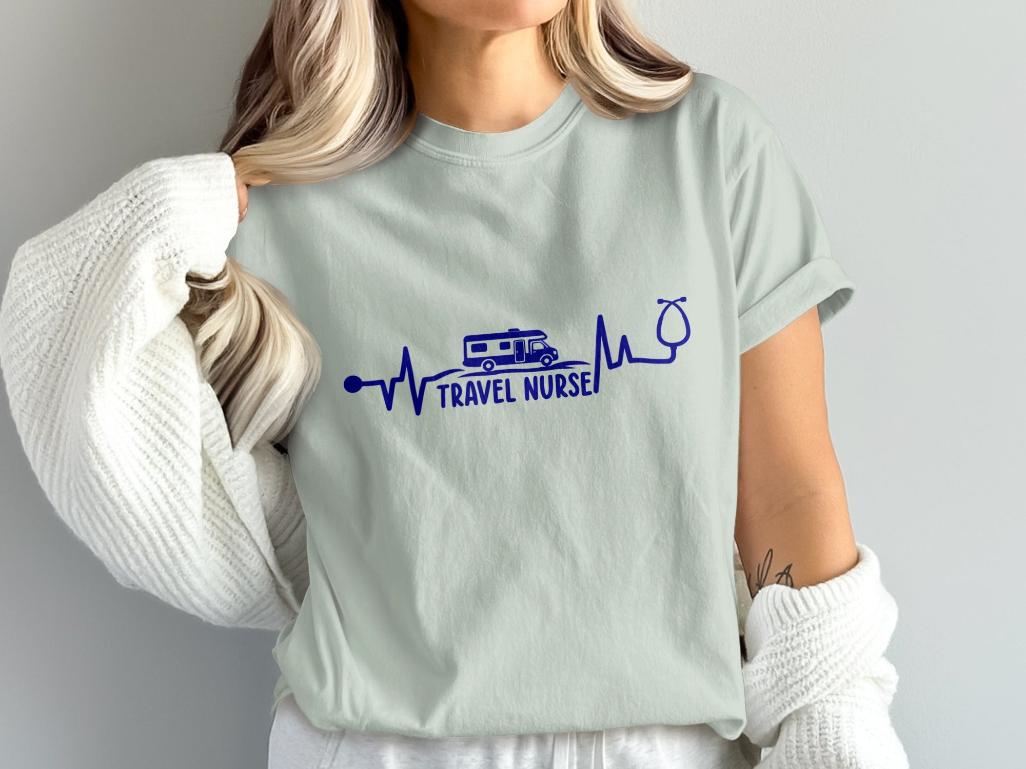 Light gray t-shirt with blue heartbeat graphic and "Travel Nurse" text.