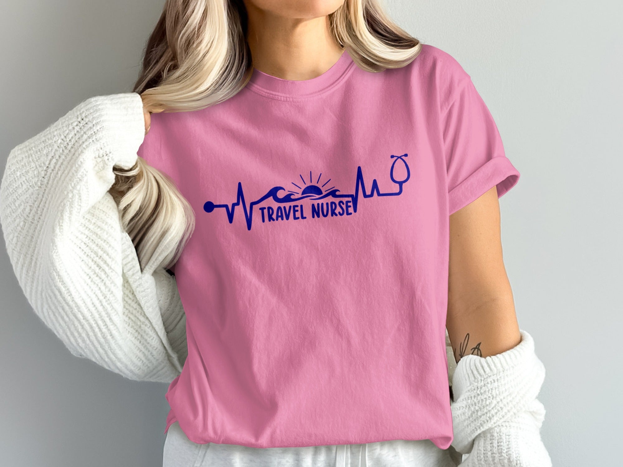 Pink t-shirt with "Travel Nurse" text and heartbeat/stethoscope graphic.