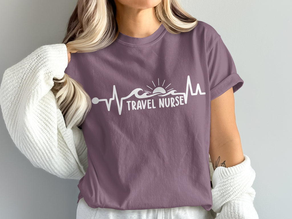 Purple t-shirt with a heartbeat wave, sun, and "TRAVEL NURSE" text.