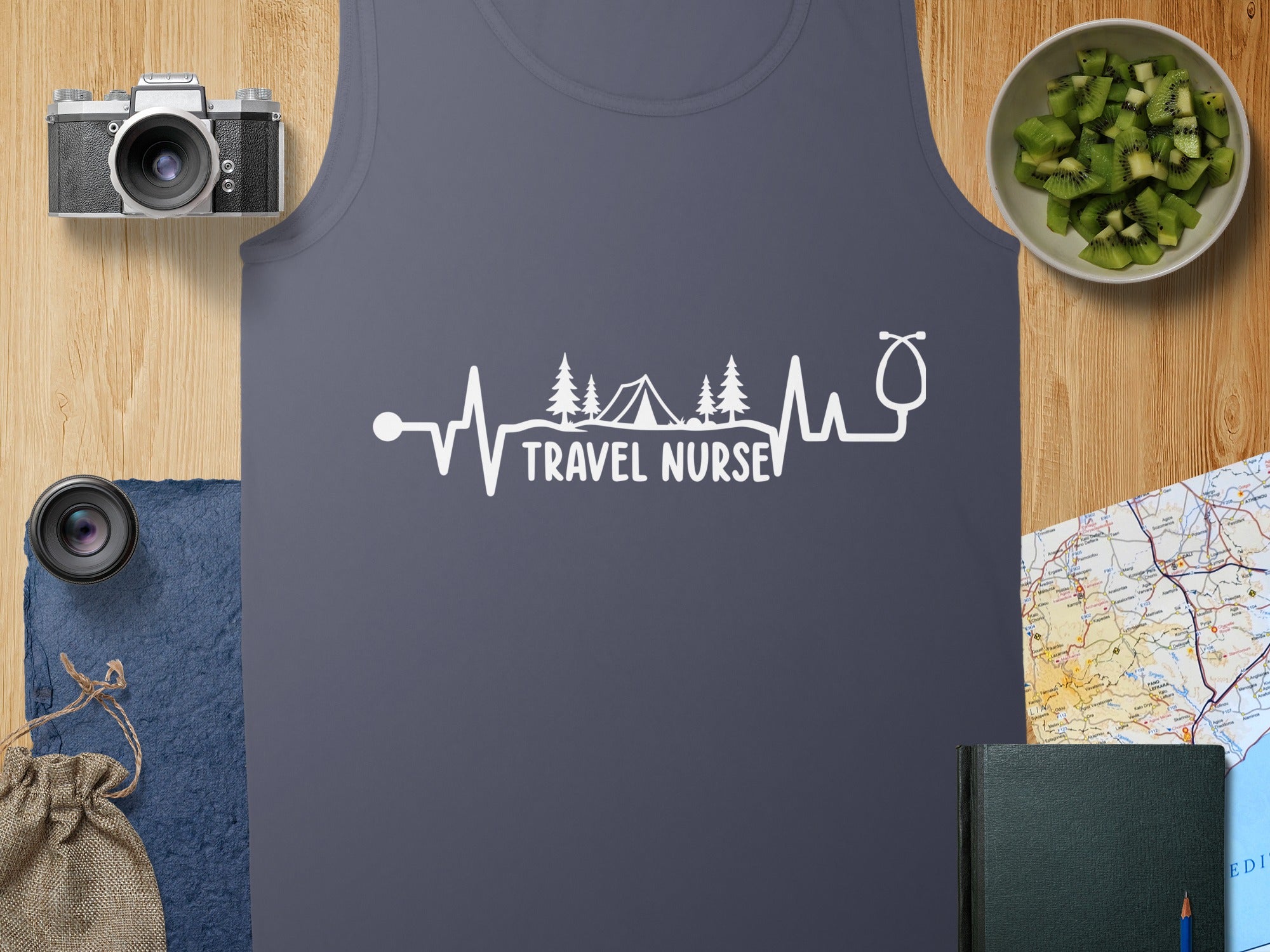 Dark grey tank top with white "TRAVEL NURSE" heartbeat and tent graphic.