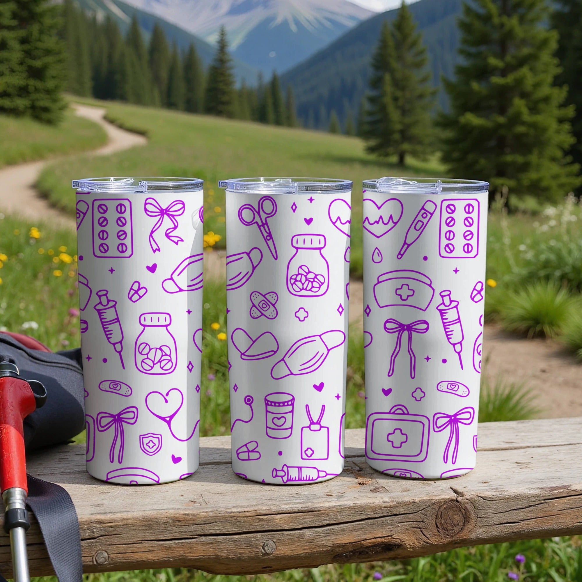 Three purple medical-themed tumblers displayed outdoors on a wooden surface.