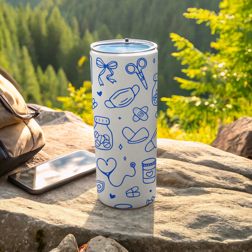 White tumbler with blue medical icons, next to phone and backpack.