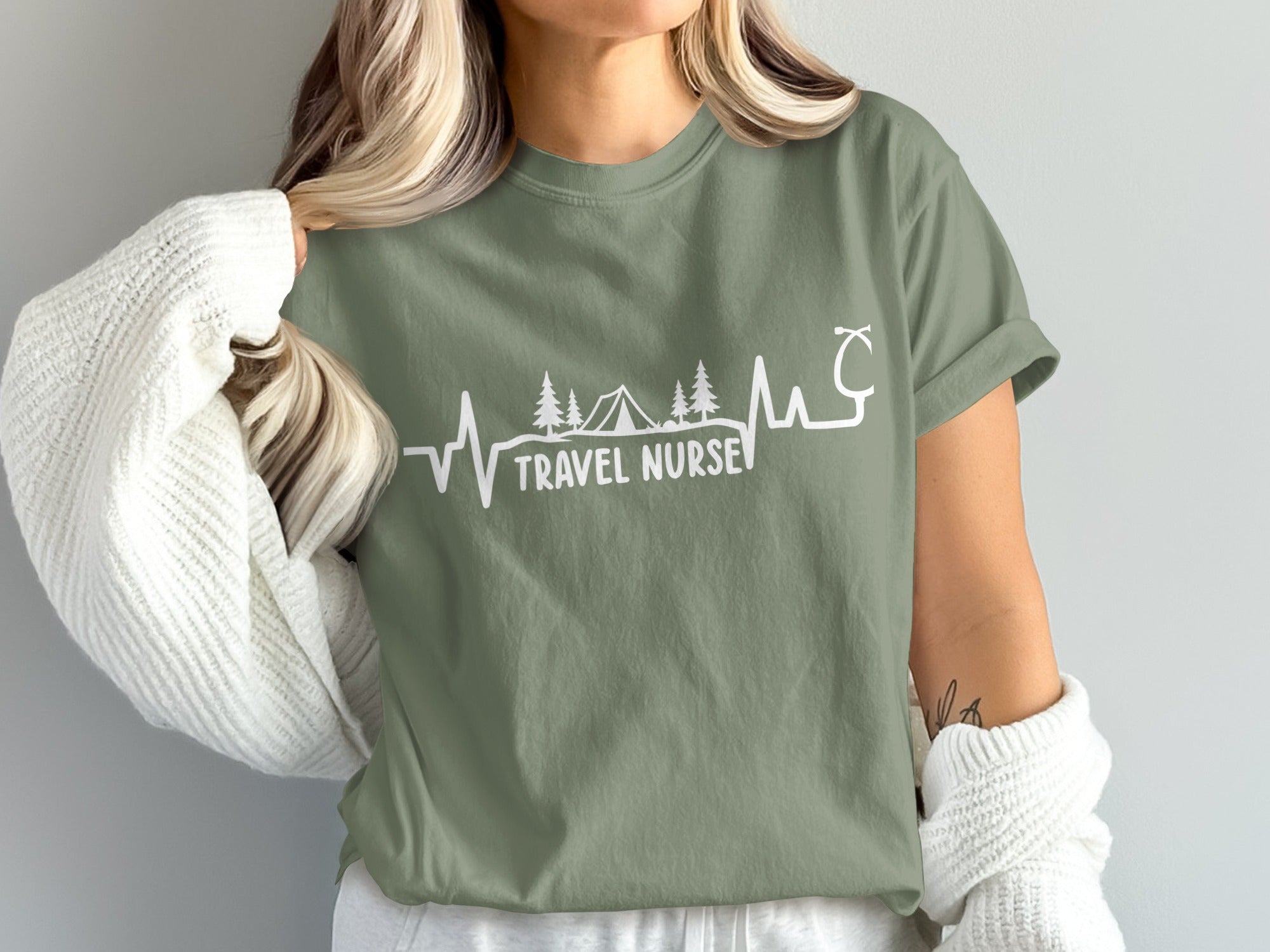 Olive green t-shirt with "TRAVEL NURSE" text and heartbeat graphic.