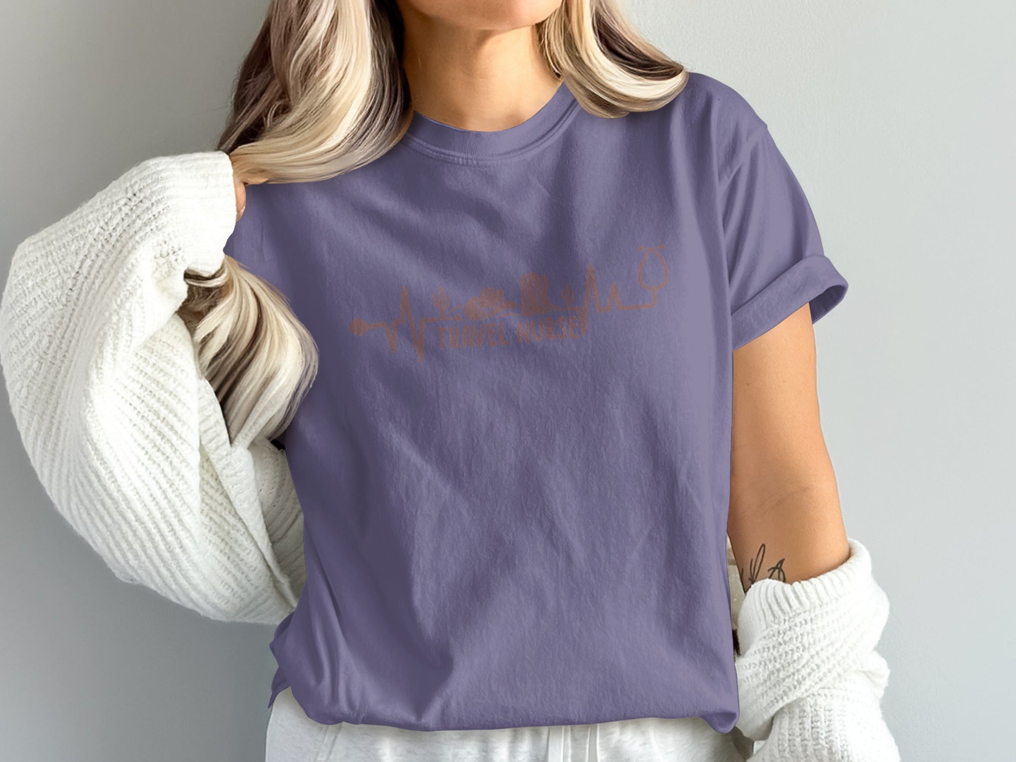 Purple t-shirt with copper heartbeat design and stethoscope.