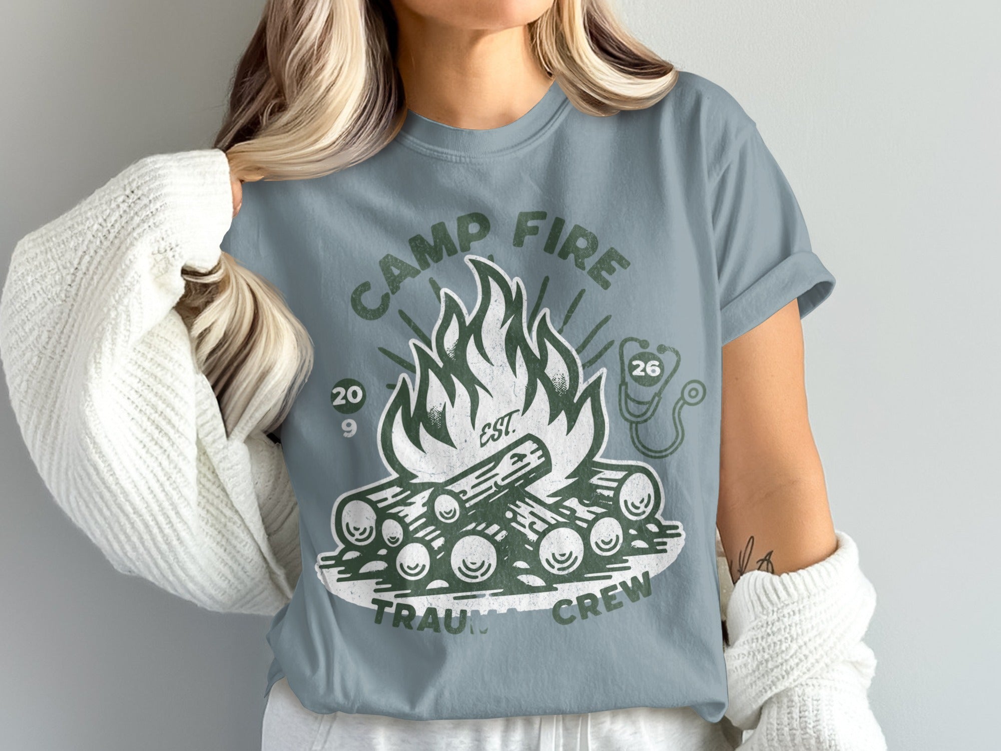 Camp Fire Trauma Crew graphic t-shirt with logs and flame design.