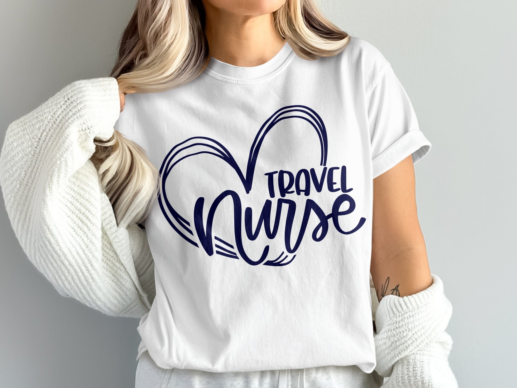 White t-shirt with navy blue "Travel Nurse" heart graphic.