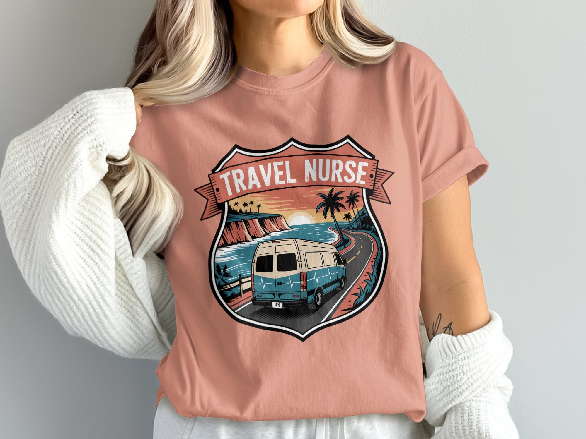 Van driving down coastal road with "Travel Nurse" crest.