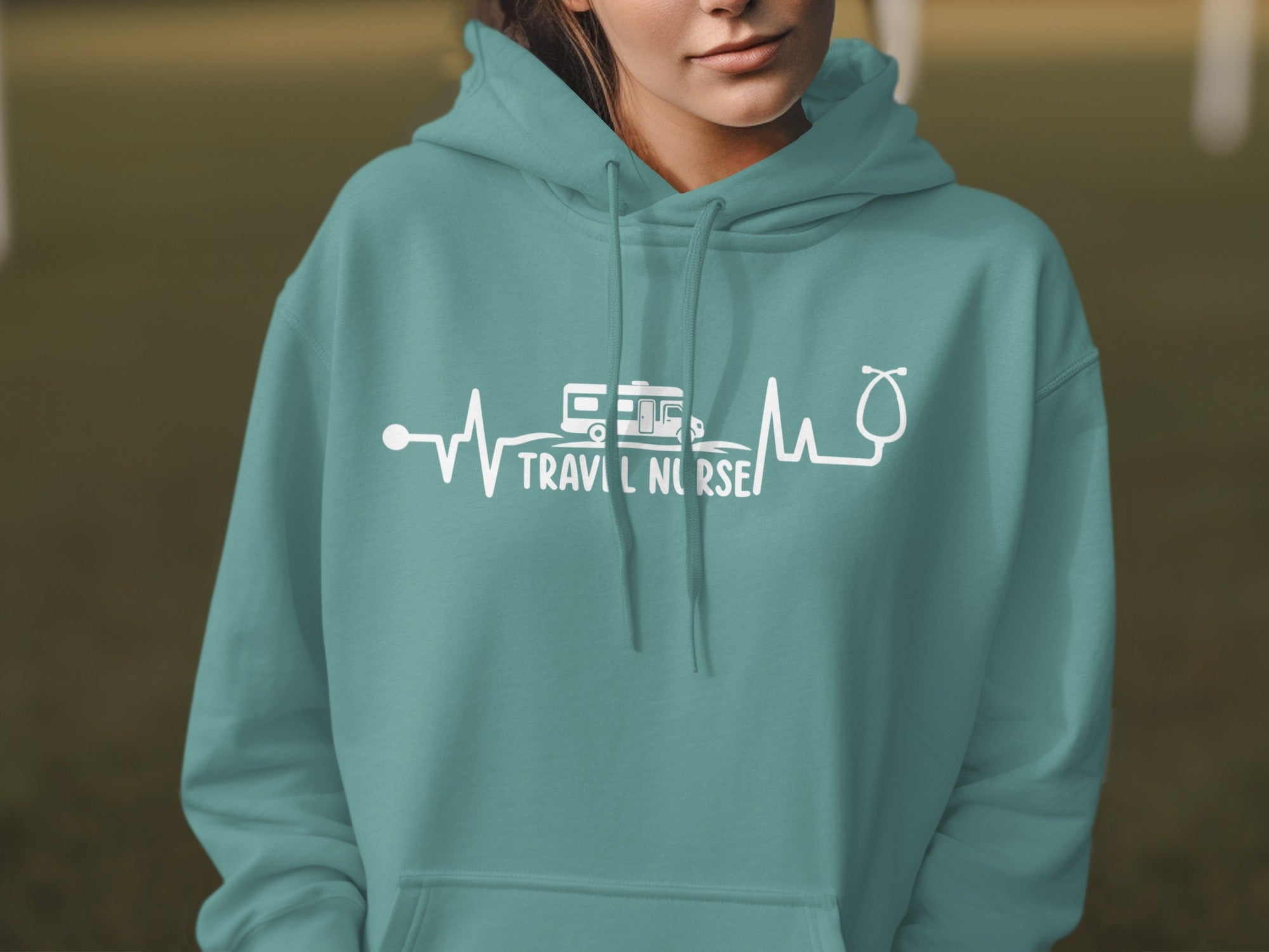 Teal hoodie with white "Travel Nurse" text and heartbeat graphic.