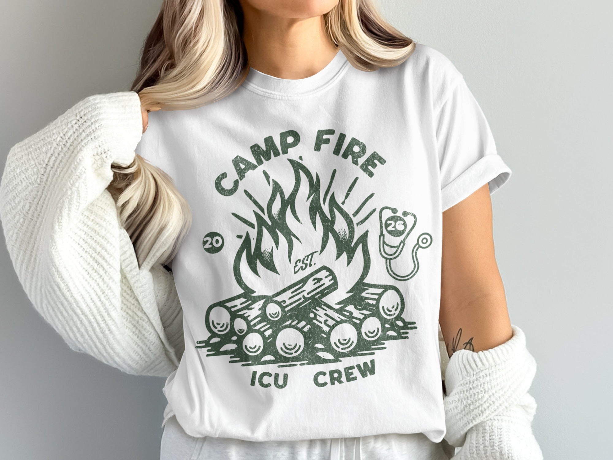 White t-shirt with green "Camp Fire ICU Crew" text and campfire graphic.
