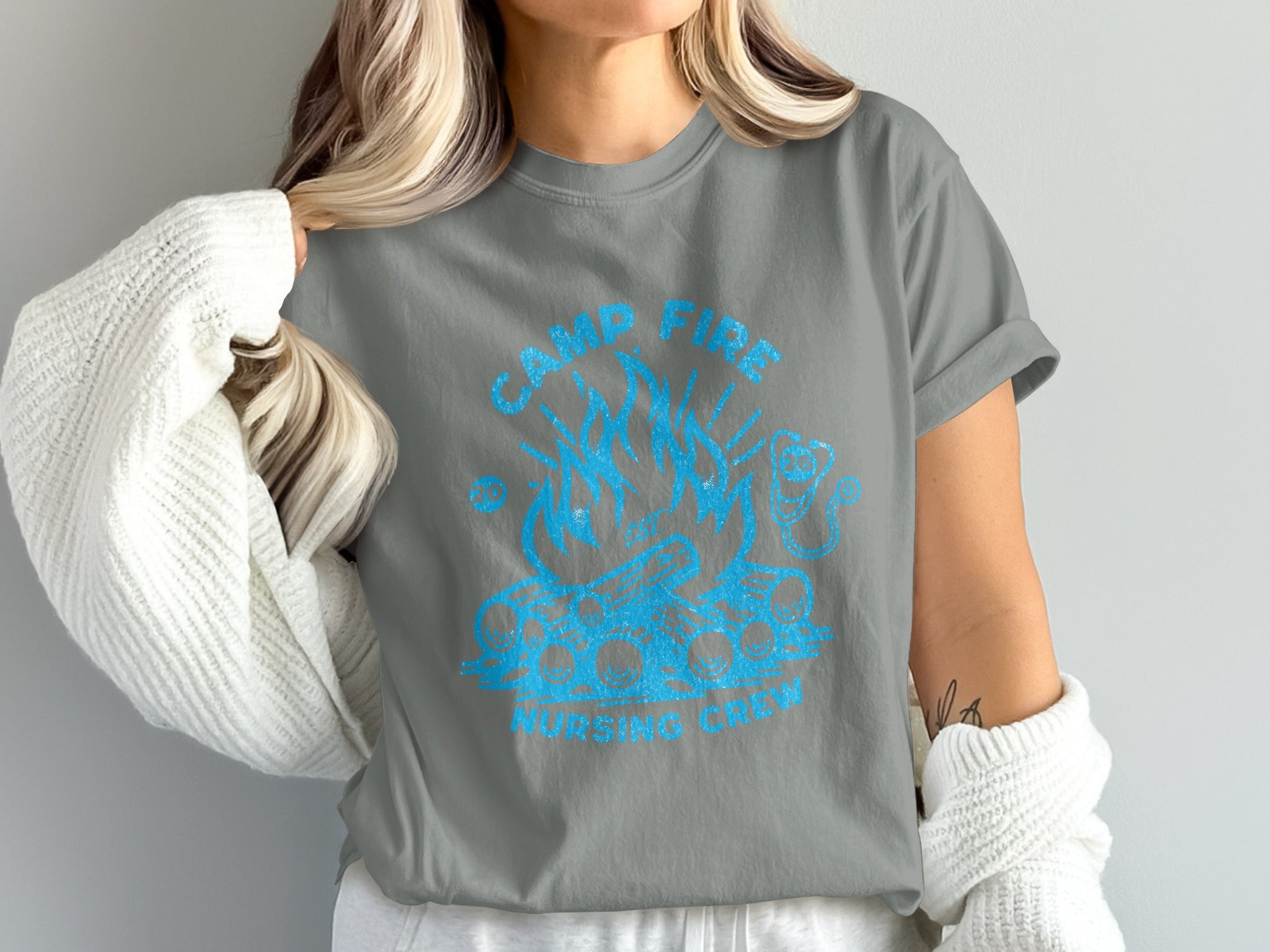 T-shirt with blue graphic of campfire and text "CAMP FIRE NURSING CREW".