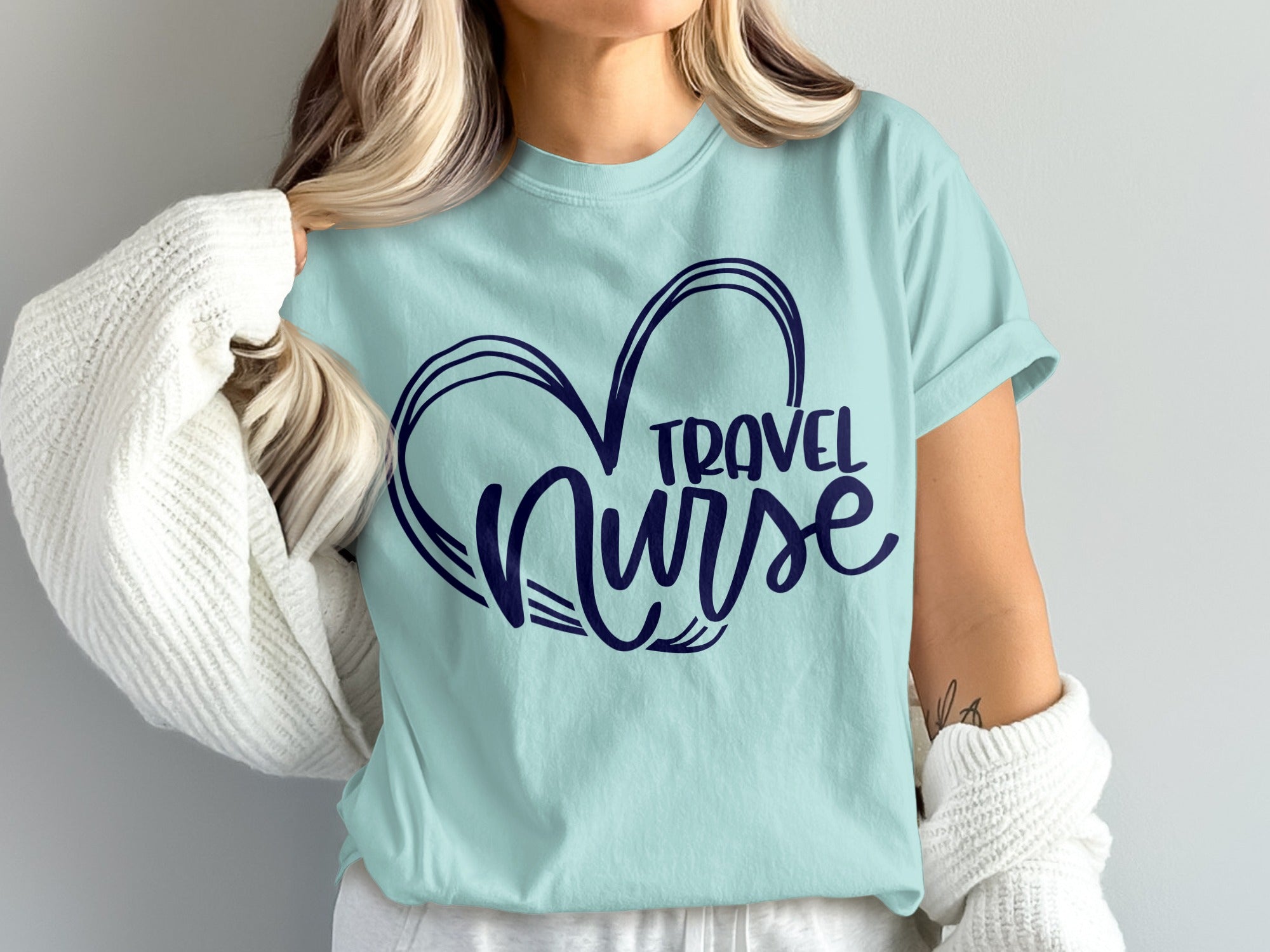 Light blue t-shirt with dark blue heart outline and "Travel Nurse" text.