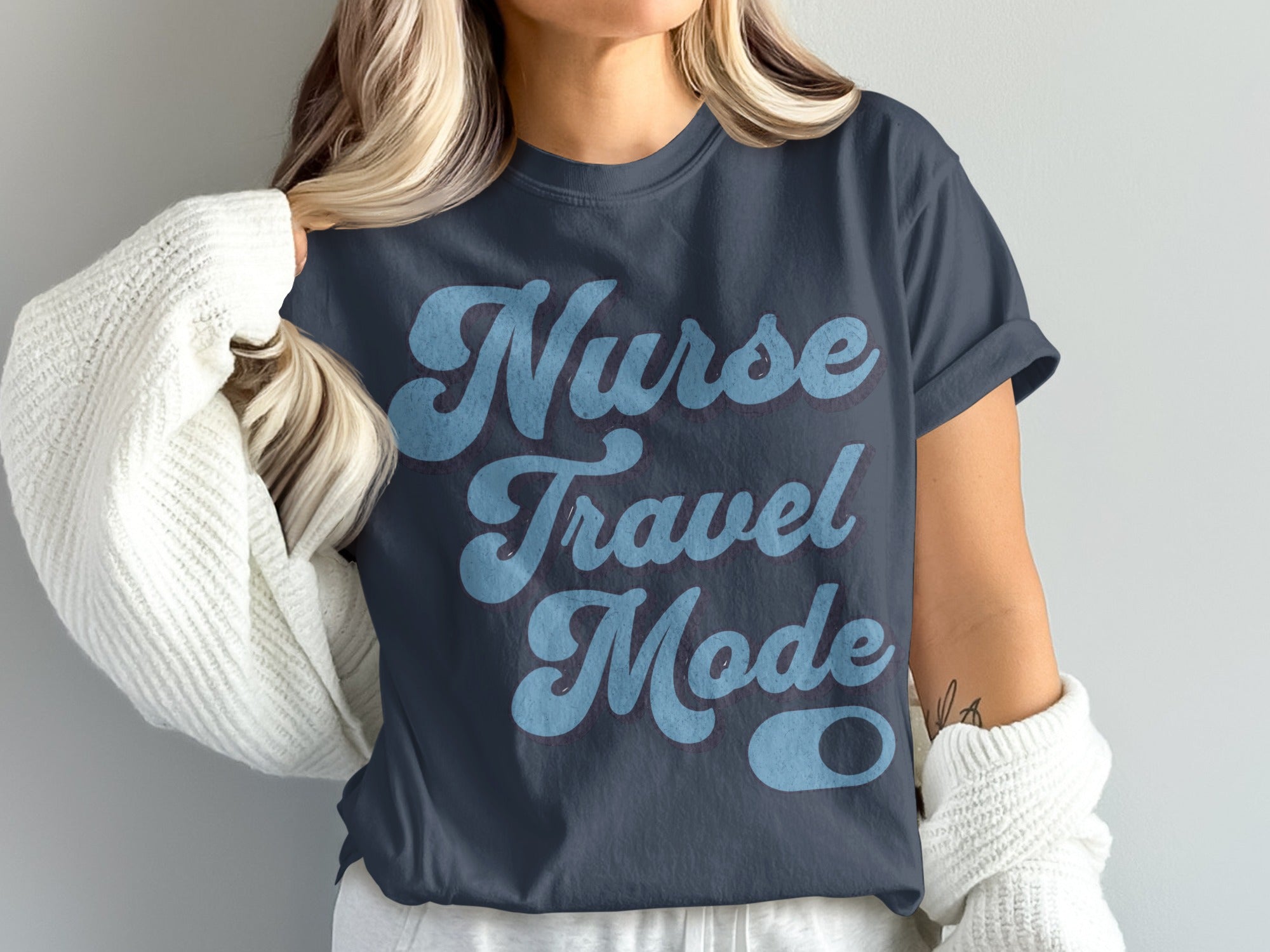 Dark blue t-shirt with text "Nurse Travel Mode" in retro blue lettering.
