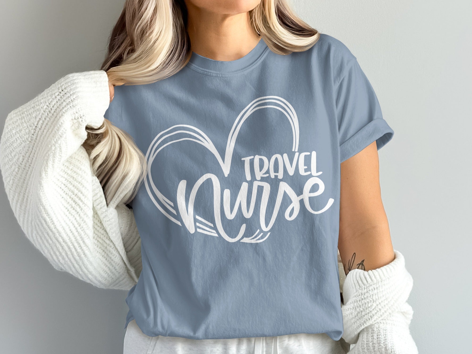 Blue t-shirt with white heart outline and "Travel Nurse" text.