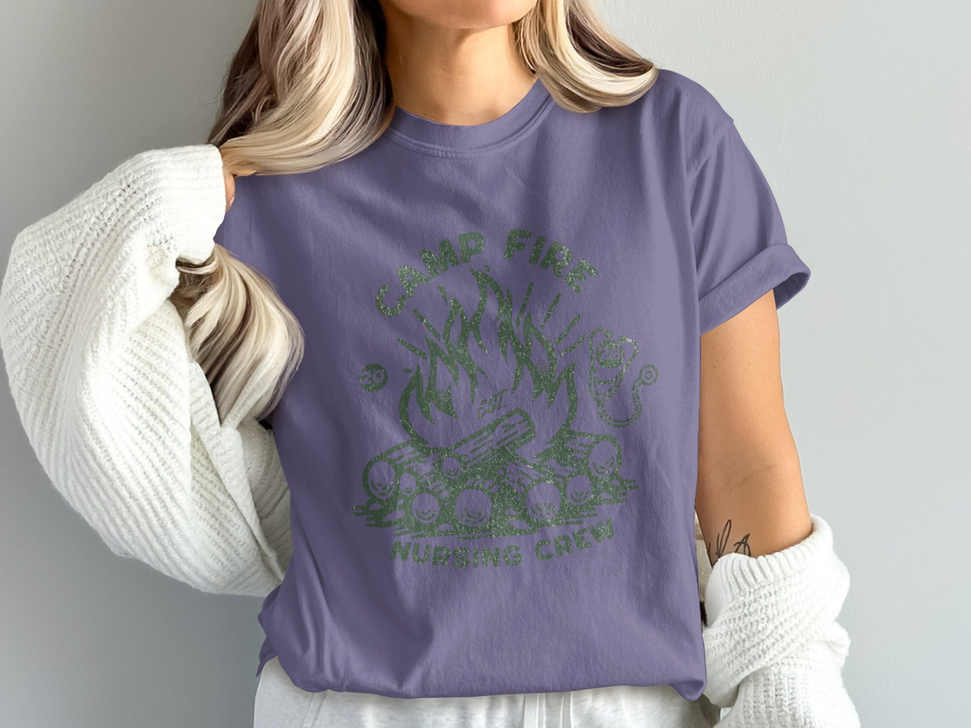 Camp Fire Nursing Crew graphic on a purple t-shirt.