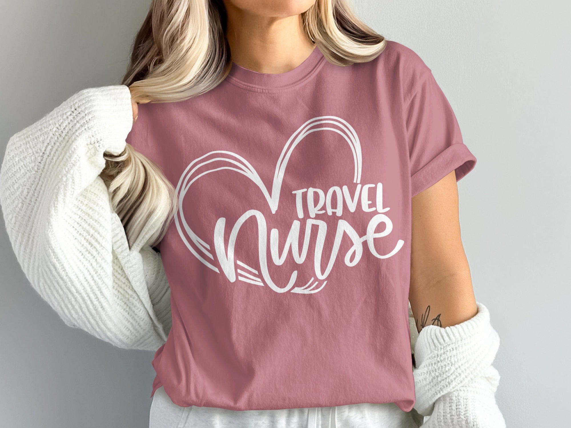 Pink t-shirt with white heart and "Travel Nurse" text.