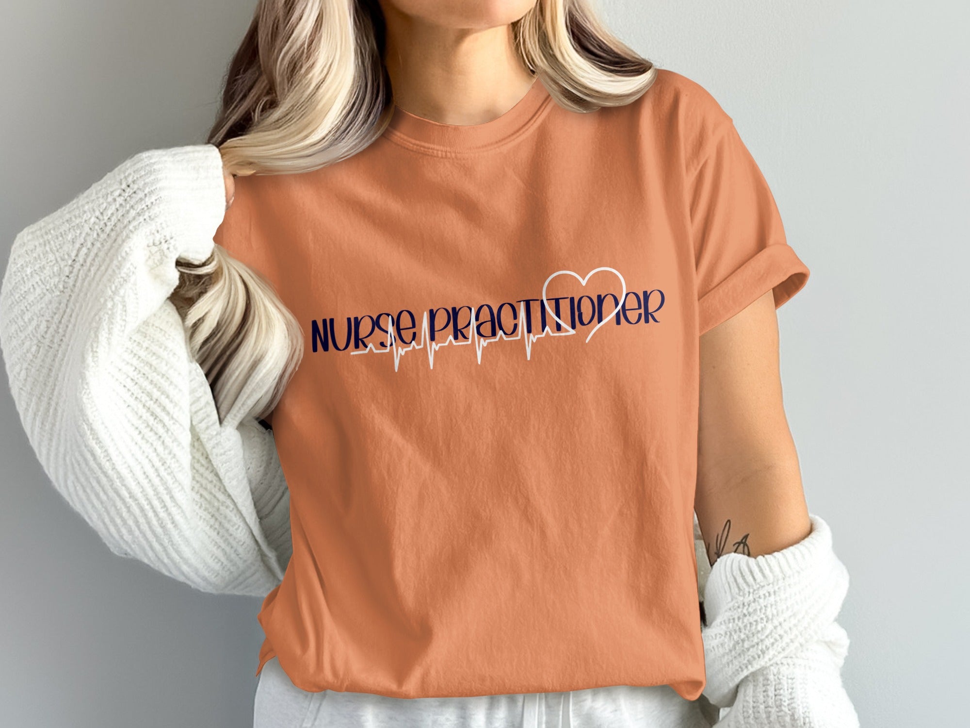 Orange t-shirt with "Nurse Practitioner" and a heartbeat EKG design.
