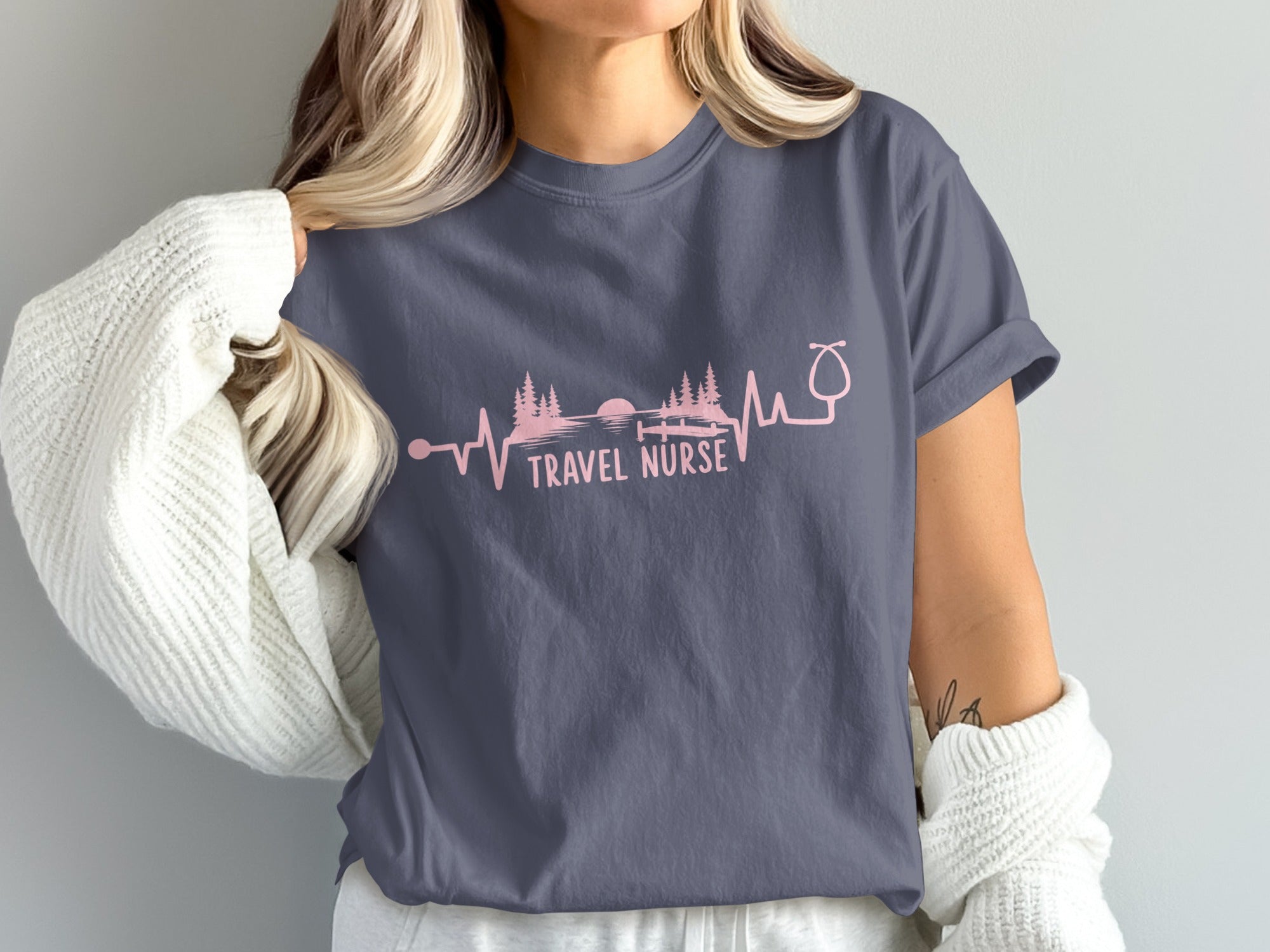 Dark grey t-shirt with pink travel nurse heartbeat and trees graphic.