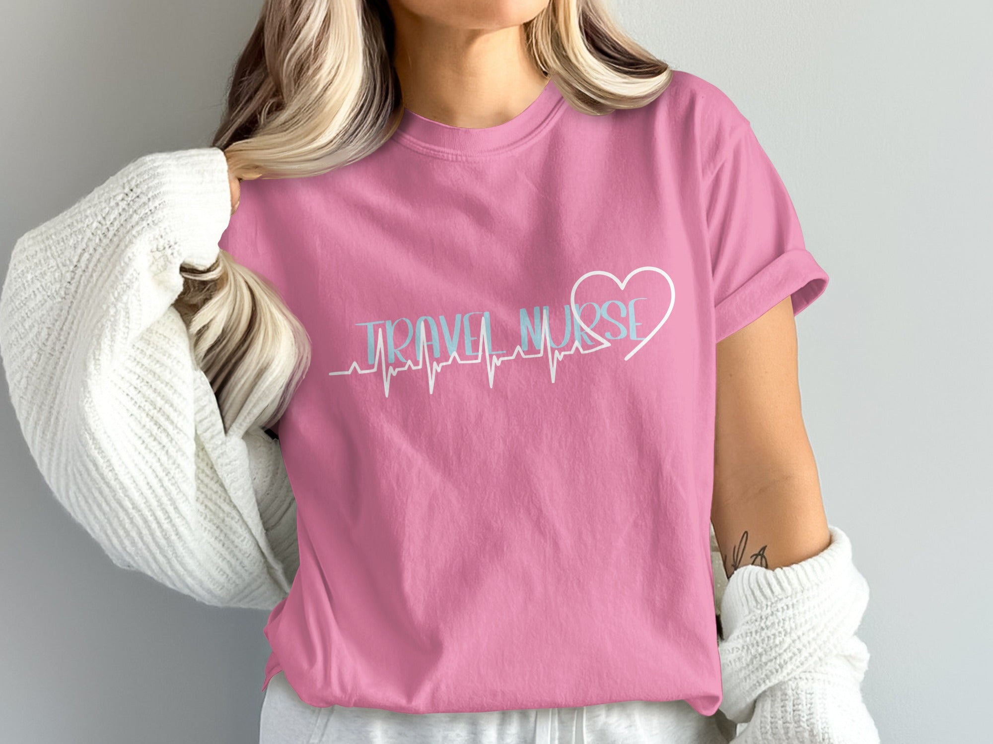 Pink t-shirt with "Travel Nurse" text and heart-shaped electrocardiogram.