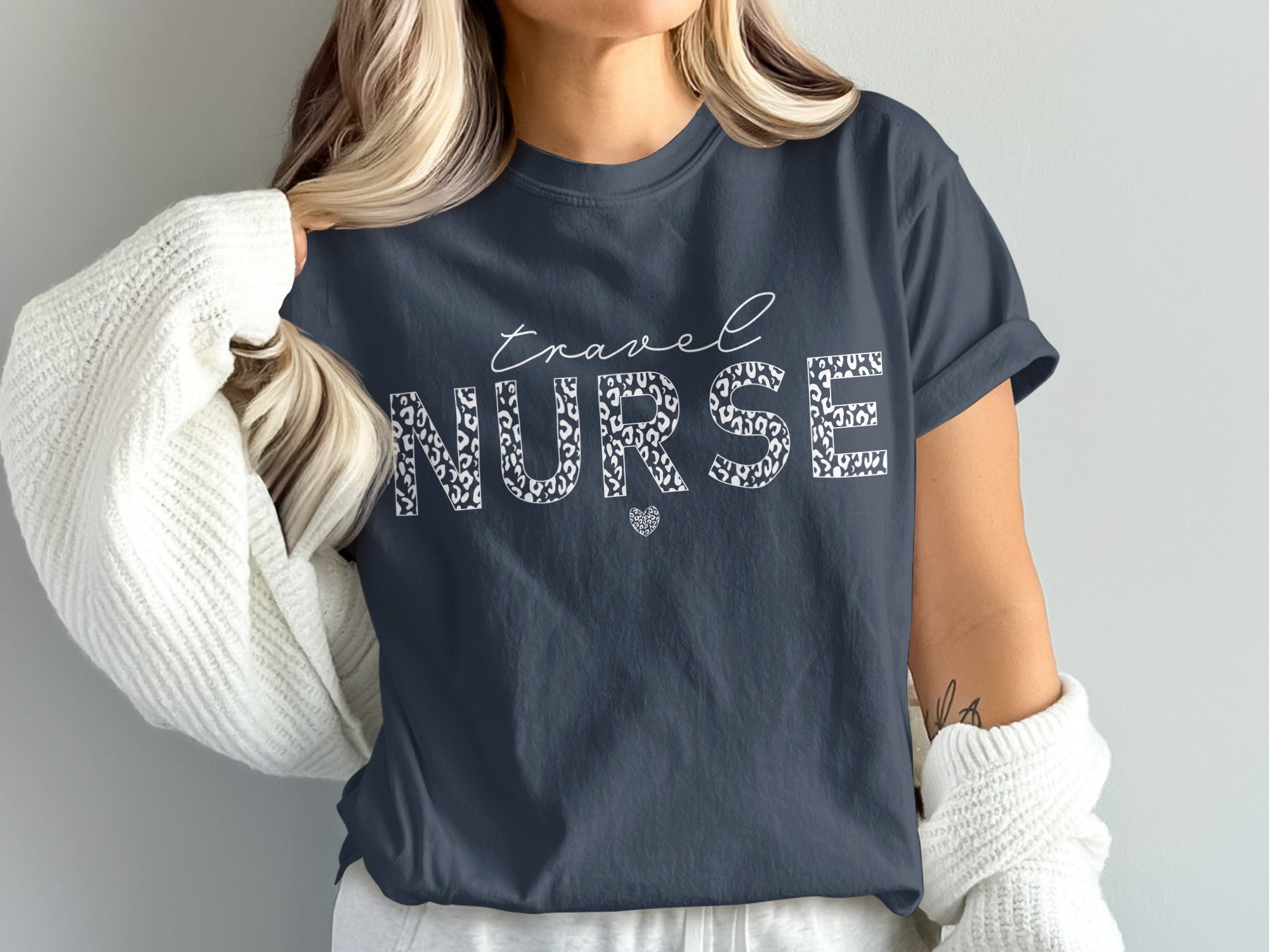 Navy t-shirt with "Travel Nurse" in leopard print and heart graphic.