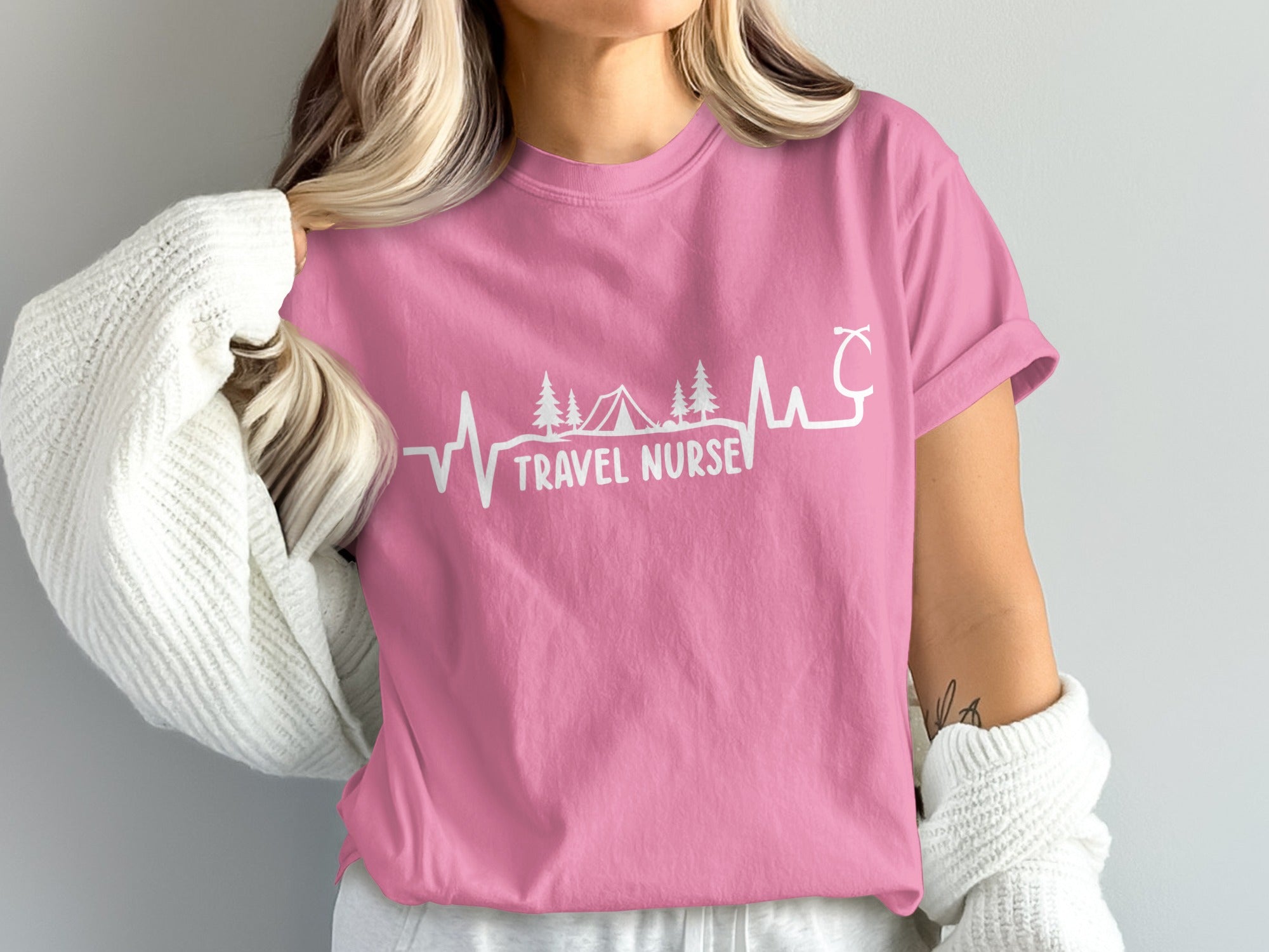 Pink t-shirt with "Travel Nurse" text, heartbeat, and nature graphic.