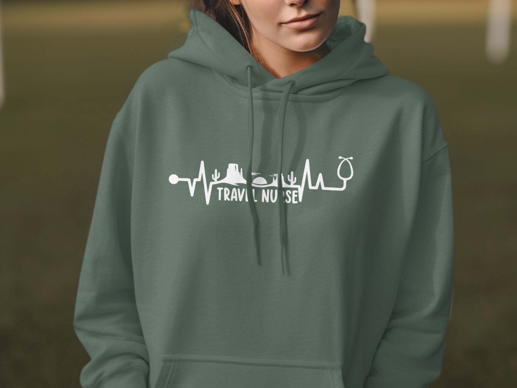 Green hoodie with white "TRAVEL NURSE" text and heartbeat graphic.