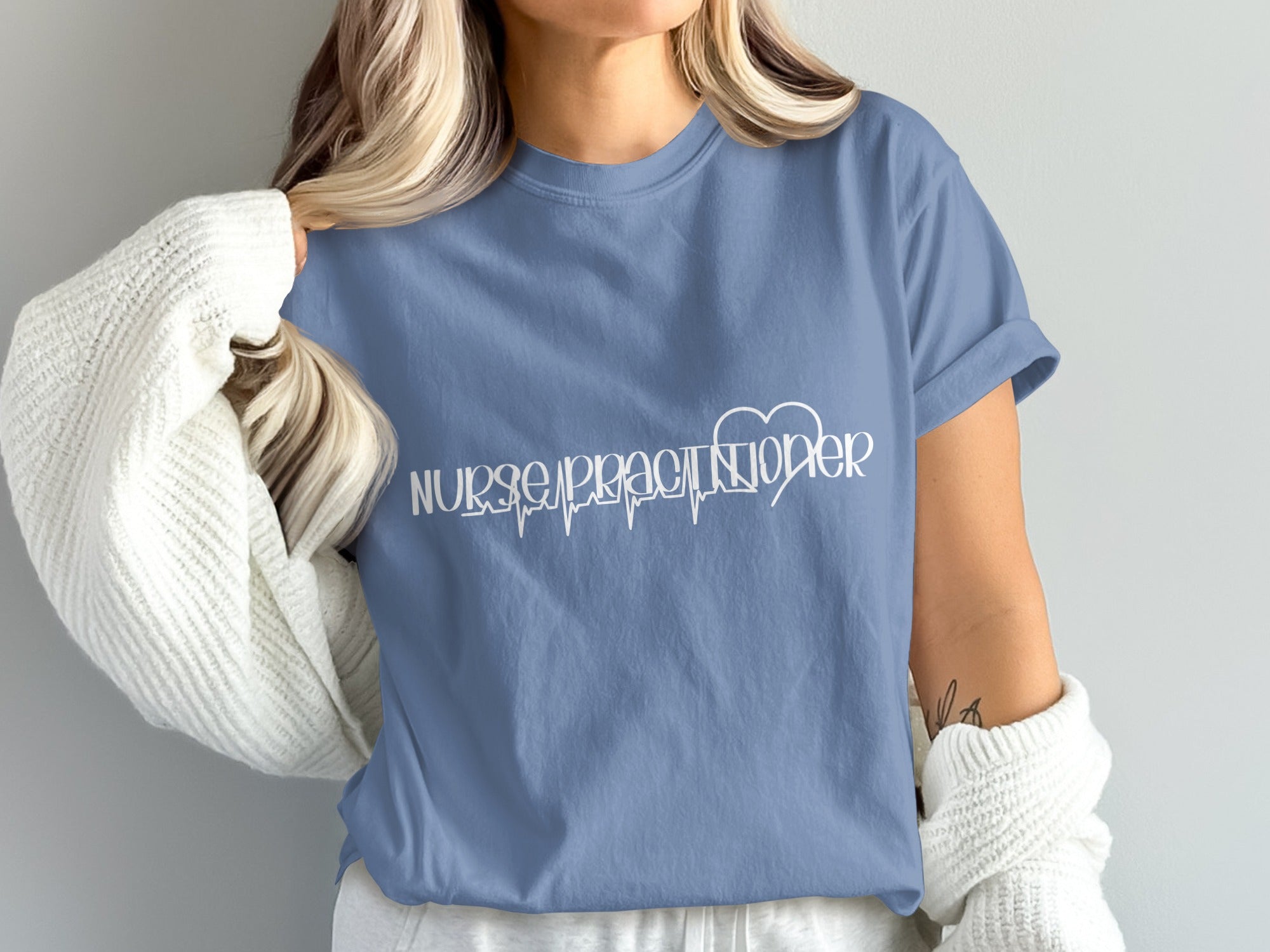 Blue t-shirt with white "Nurse Practitioner" text and a heart-shaped heartbeat line.