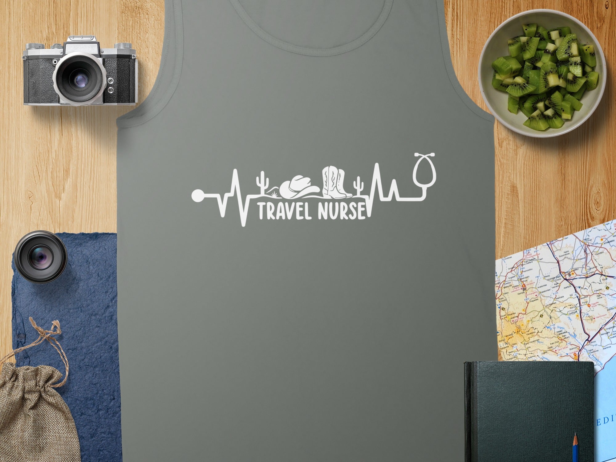 Gray tank top with "TRAVEL NURSE" heartbeat graphic, stethoscope, cowboy hat, and boots.